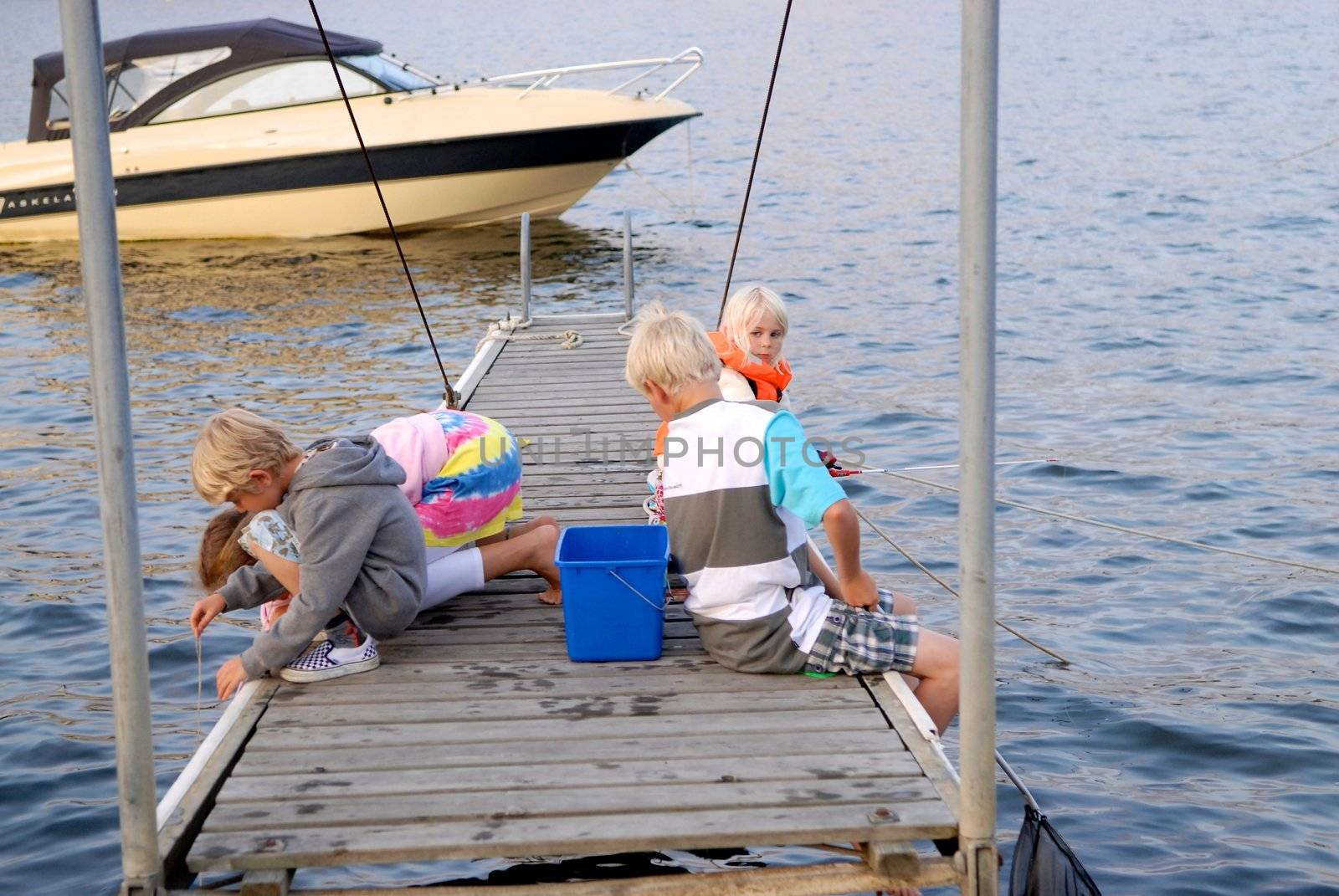 children fishing by the sea. Please note: No negative use allowed.