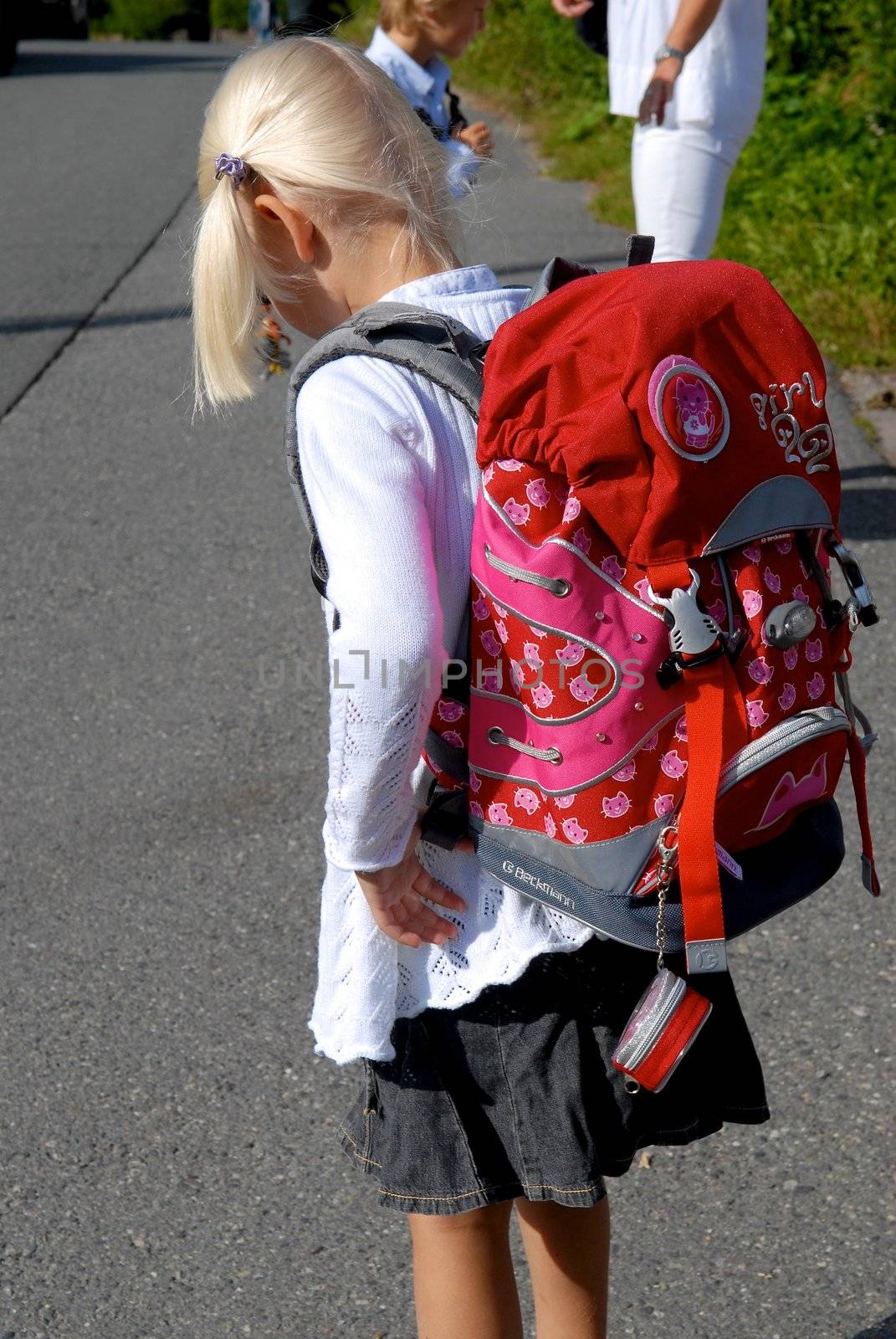 a girl with red schoolbag. Please note: No negative use allowed.