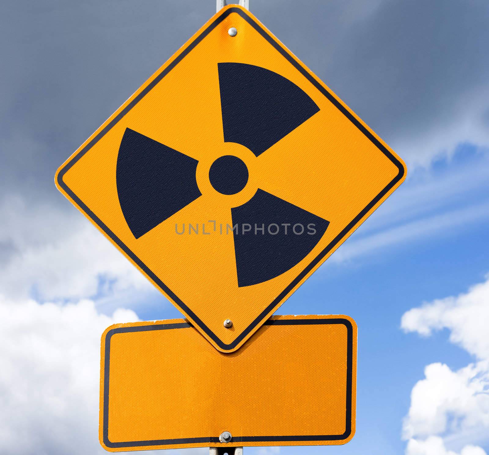 Road sign with radioactivity warning symbol on it and copyspace for your message below.