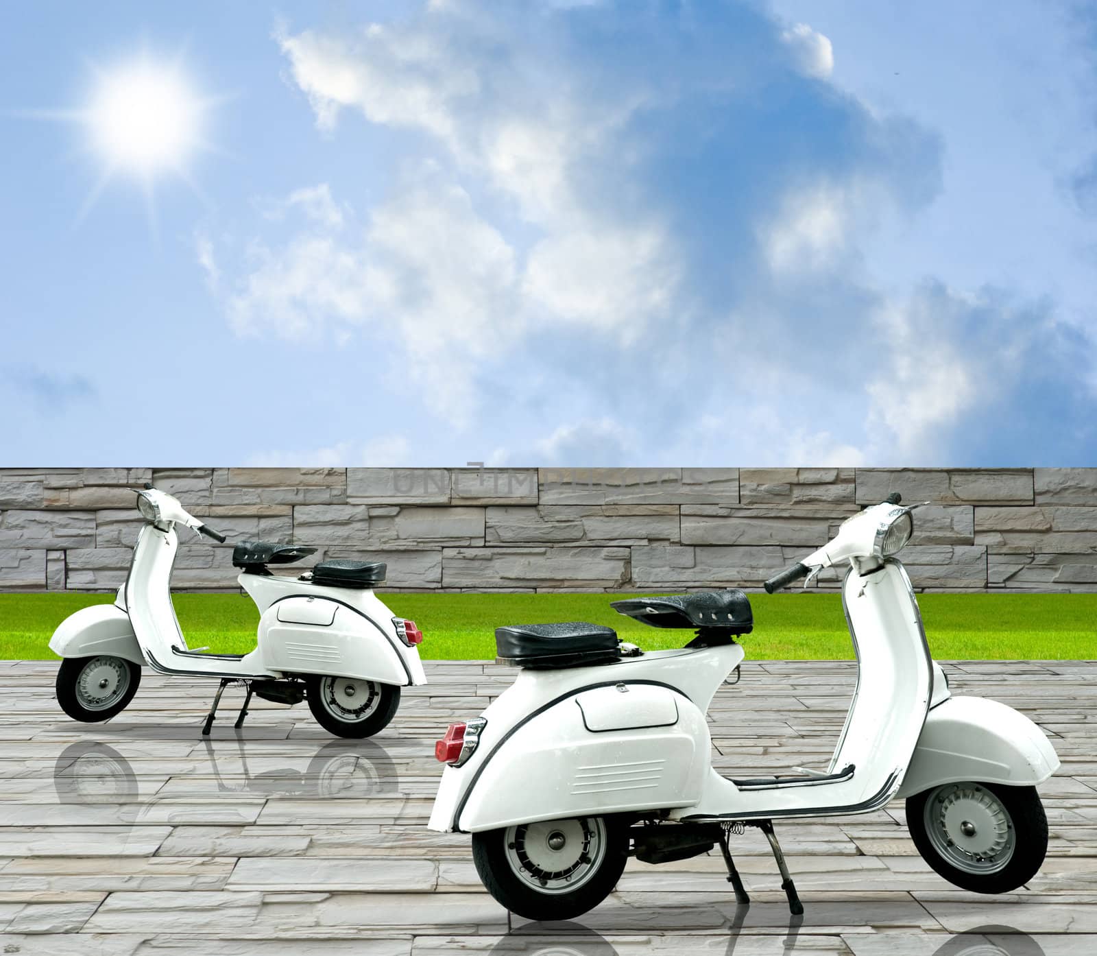 White motorbike on the decorate stone floor with nice sky