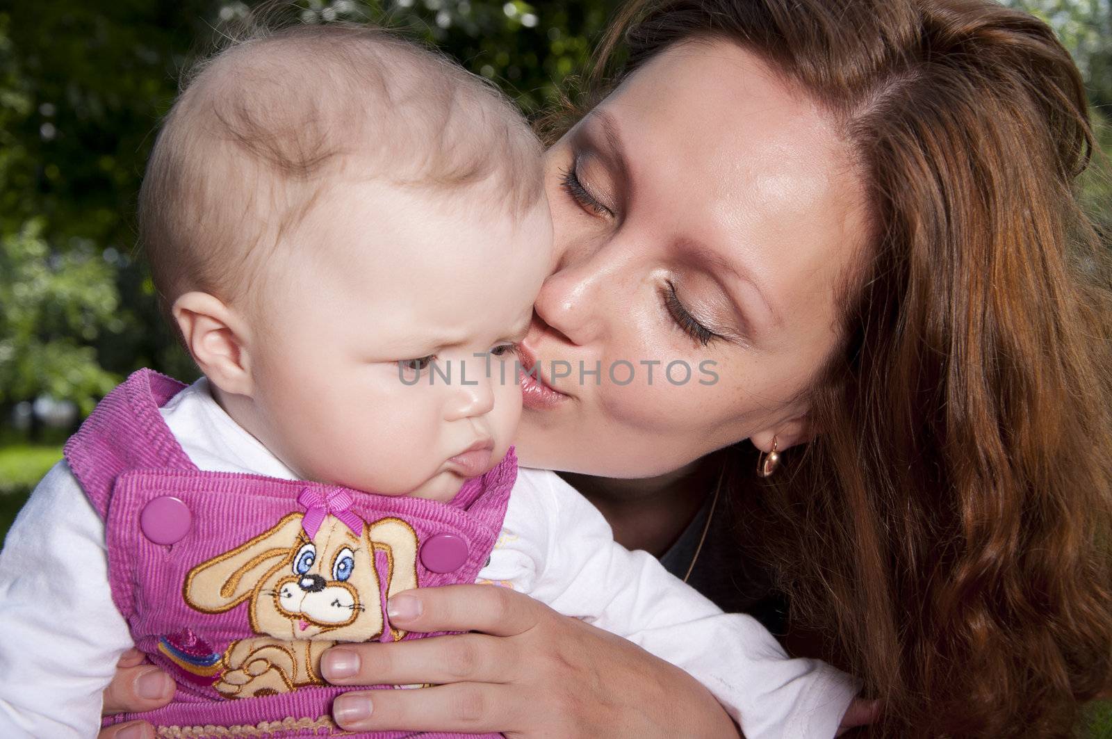 Beautiful mum kisses the child by adam121