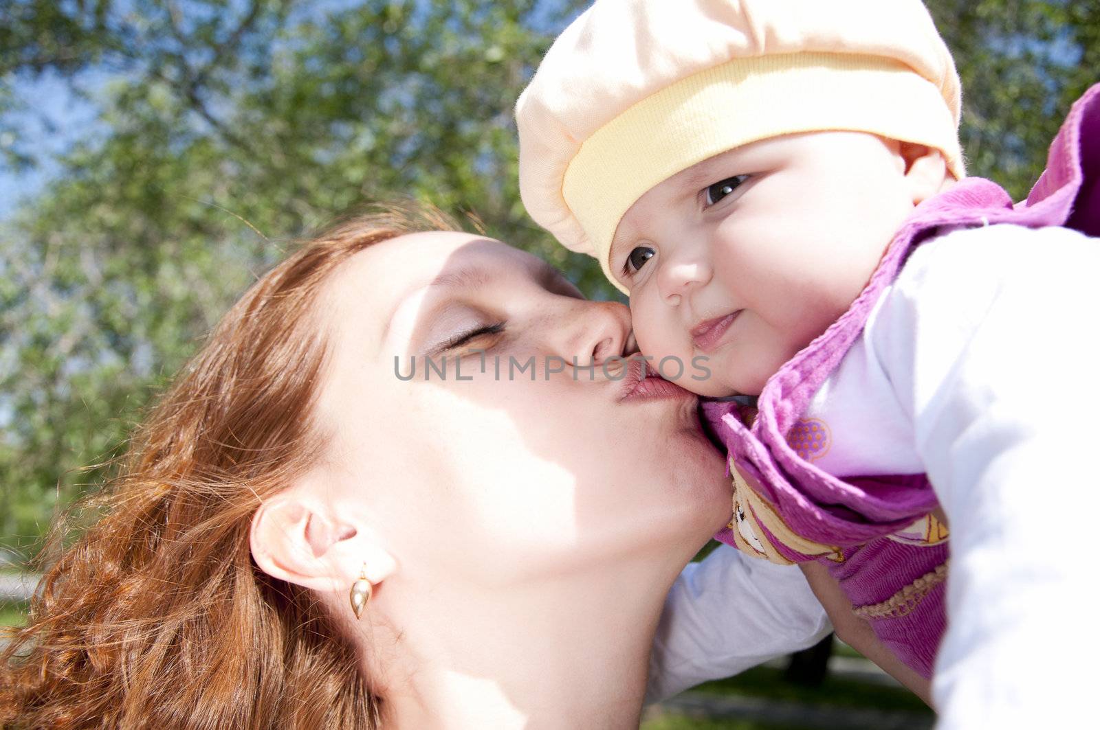 Portrait Beautiful mum kisses the child