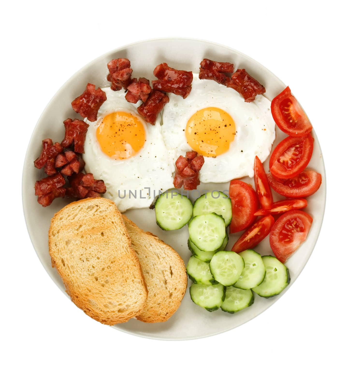 close-up of fried eggs with sausage and vegetables
