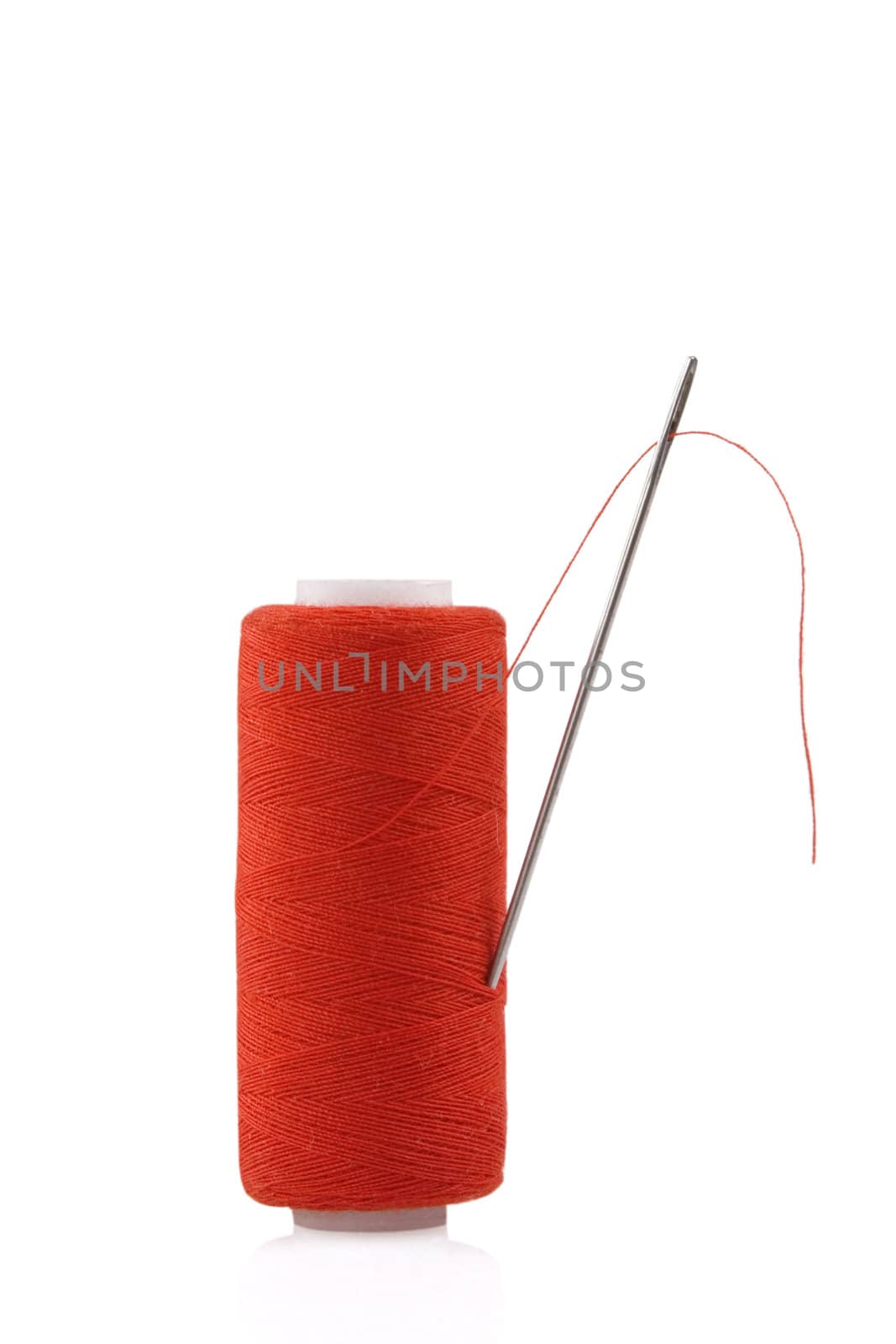 red spool with needle isolated on white background