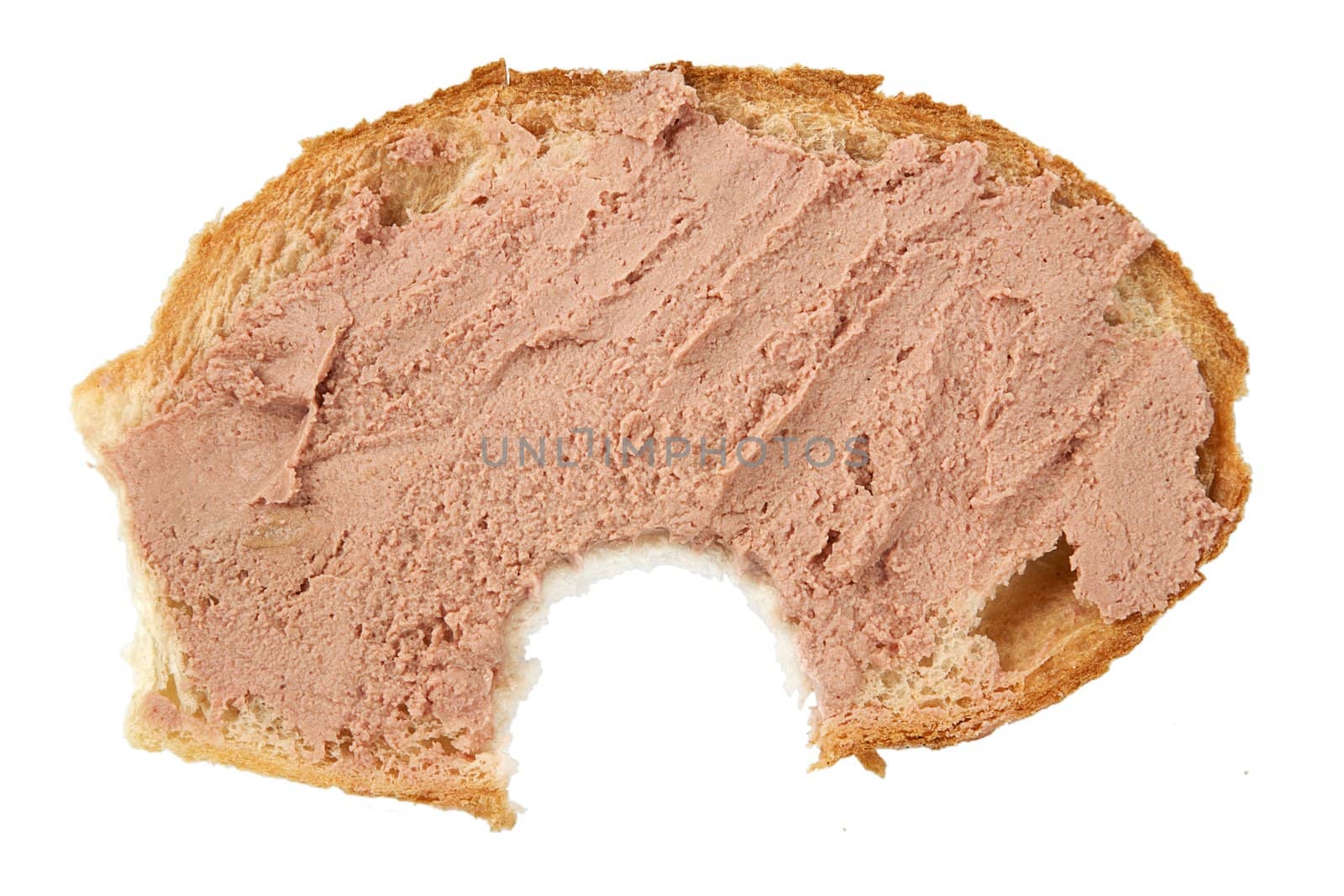 bitten slice of bread with pate on white background