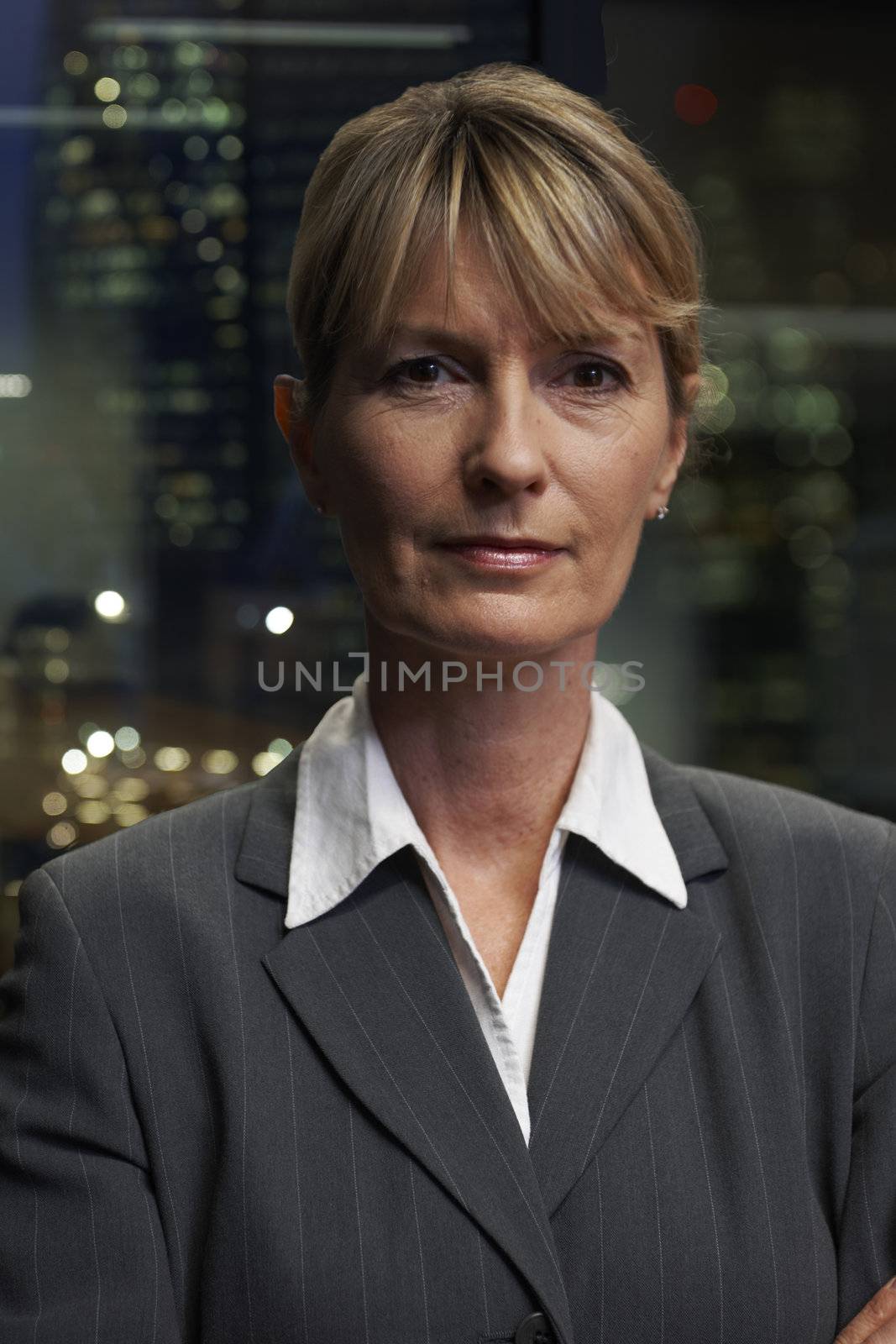 Portrait of a senior executive by a window looking at camera