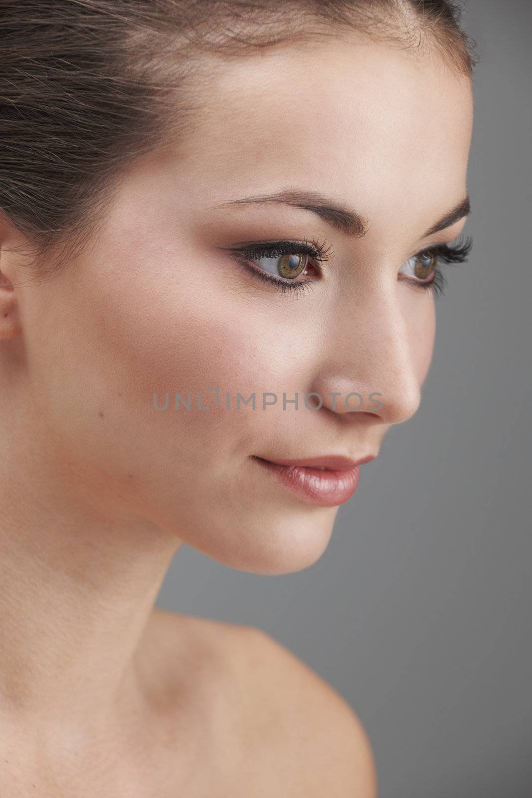 Young womans face with subtle make up and eye lash extensions
