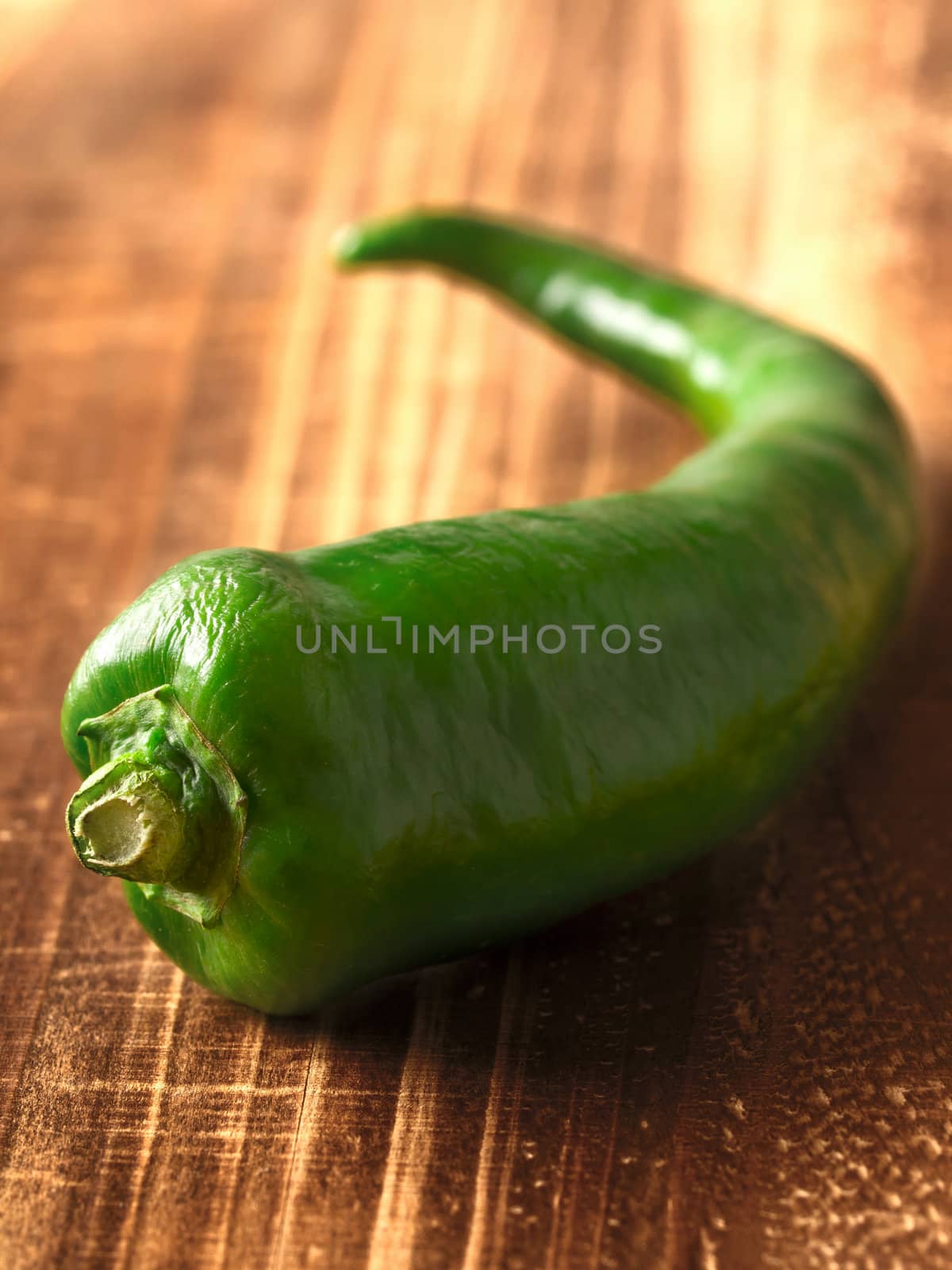 close up of a green chili on table