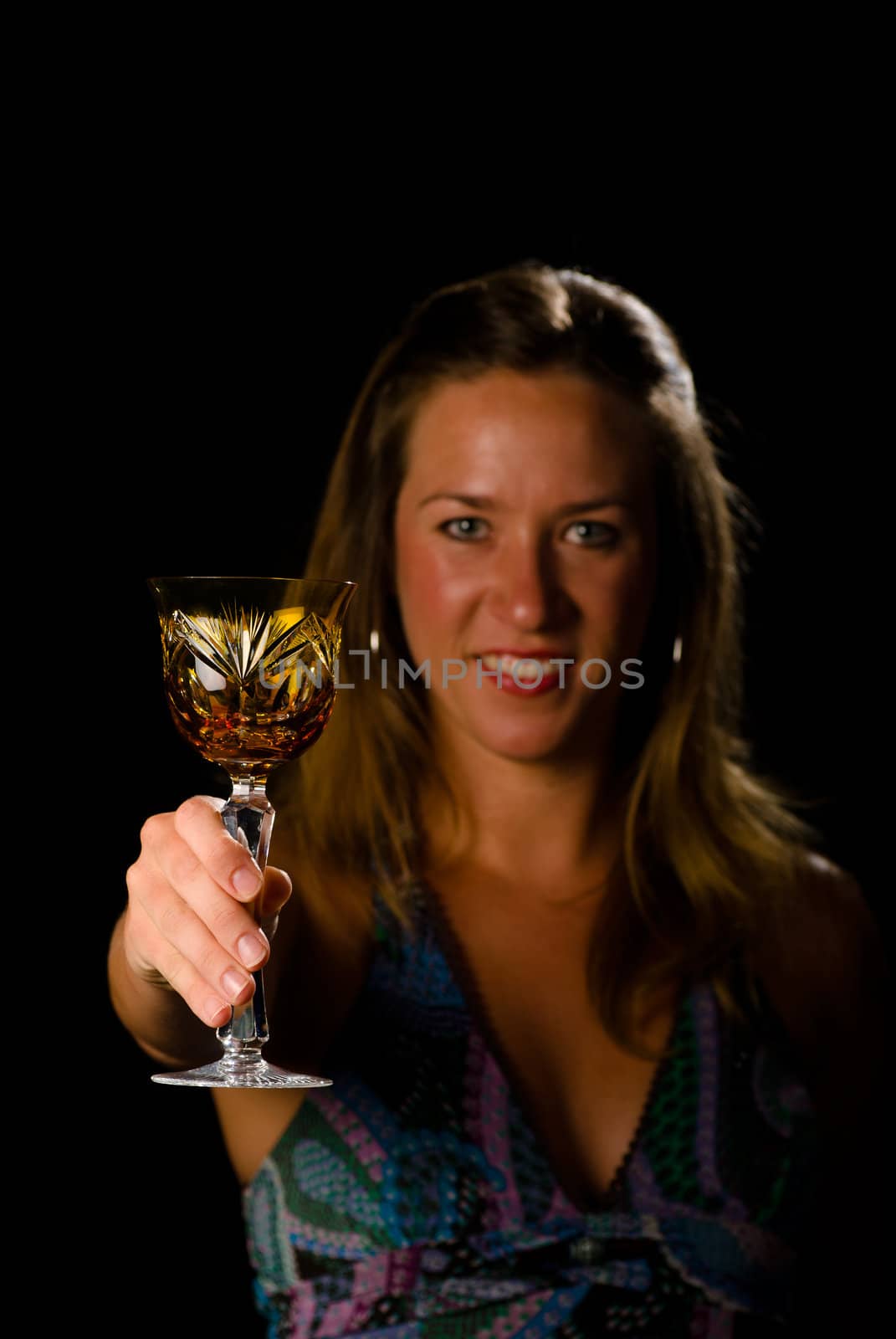 Woman toasting with classy crystal glass, copy space available