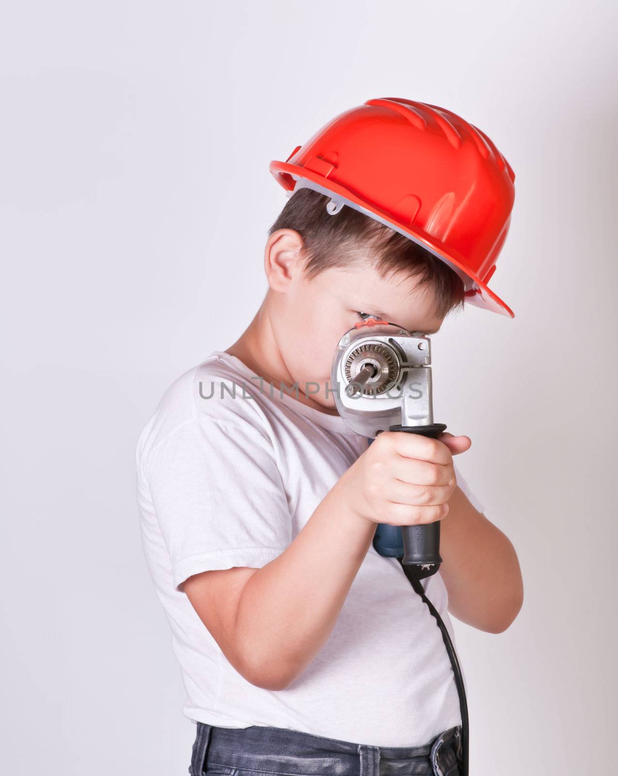 Portrait of a boy in a red protective helmet