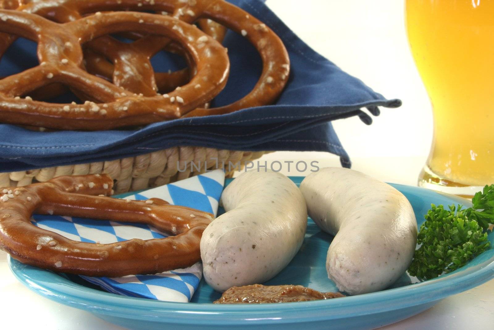 veal sausage with sweet mustard and pretzels on a white background