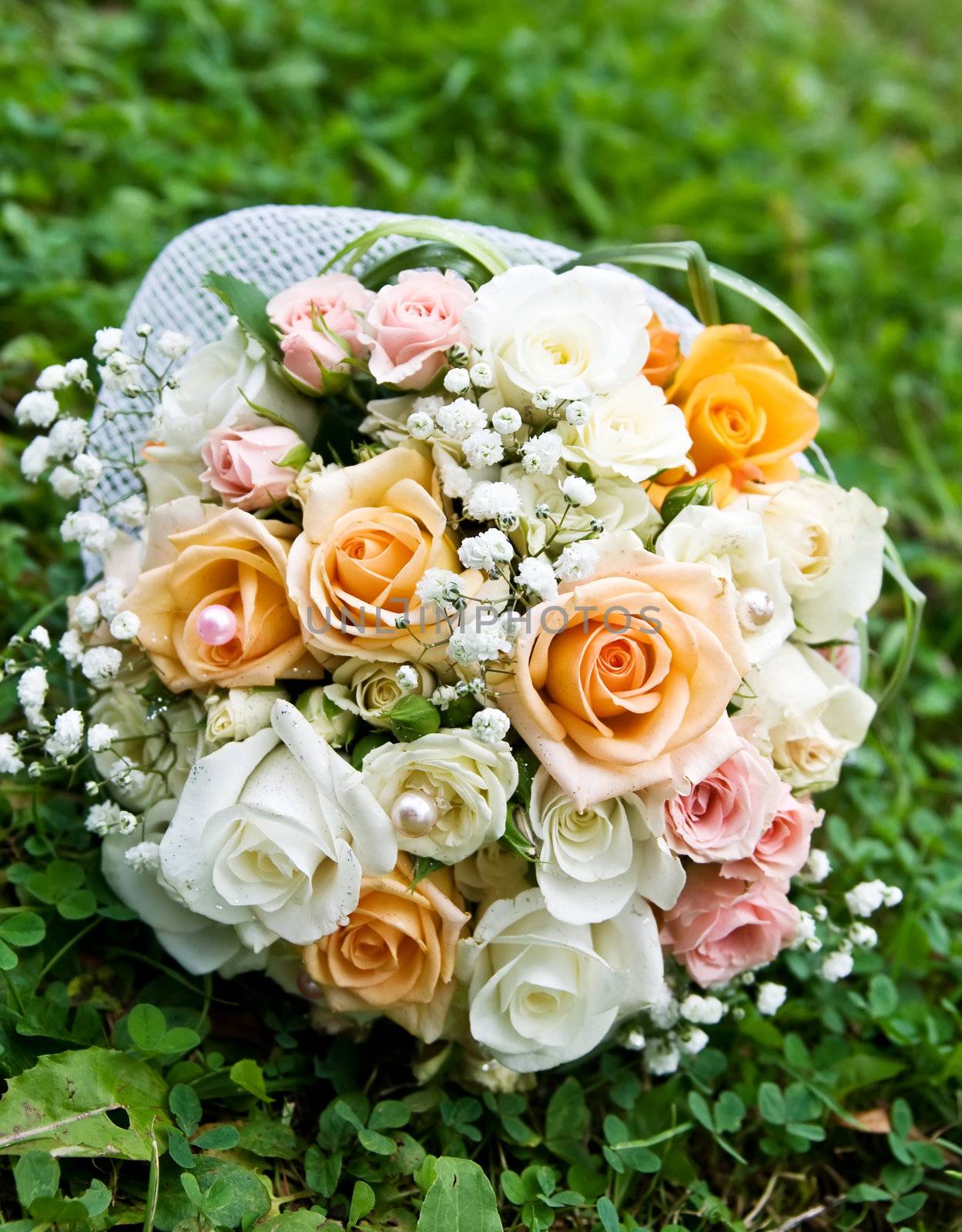 wedding bouquet of roses on green grass.