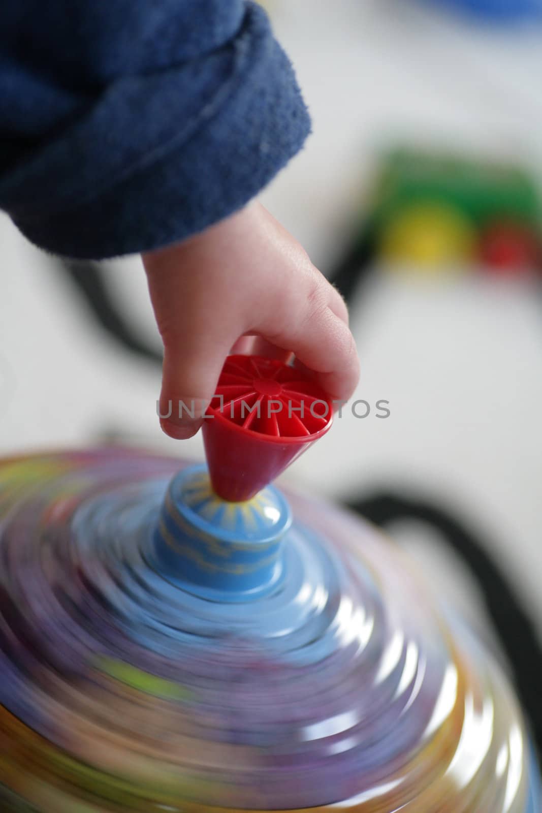 Child hand on spinner in motion