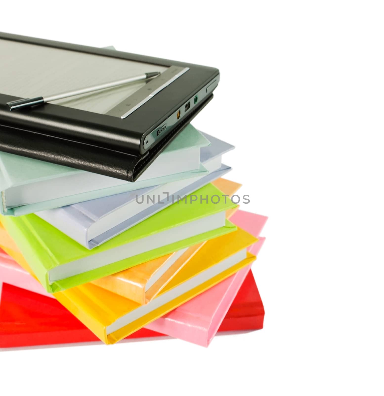 Stack of colorful books and electronic book reader on the white background