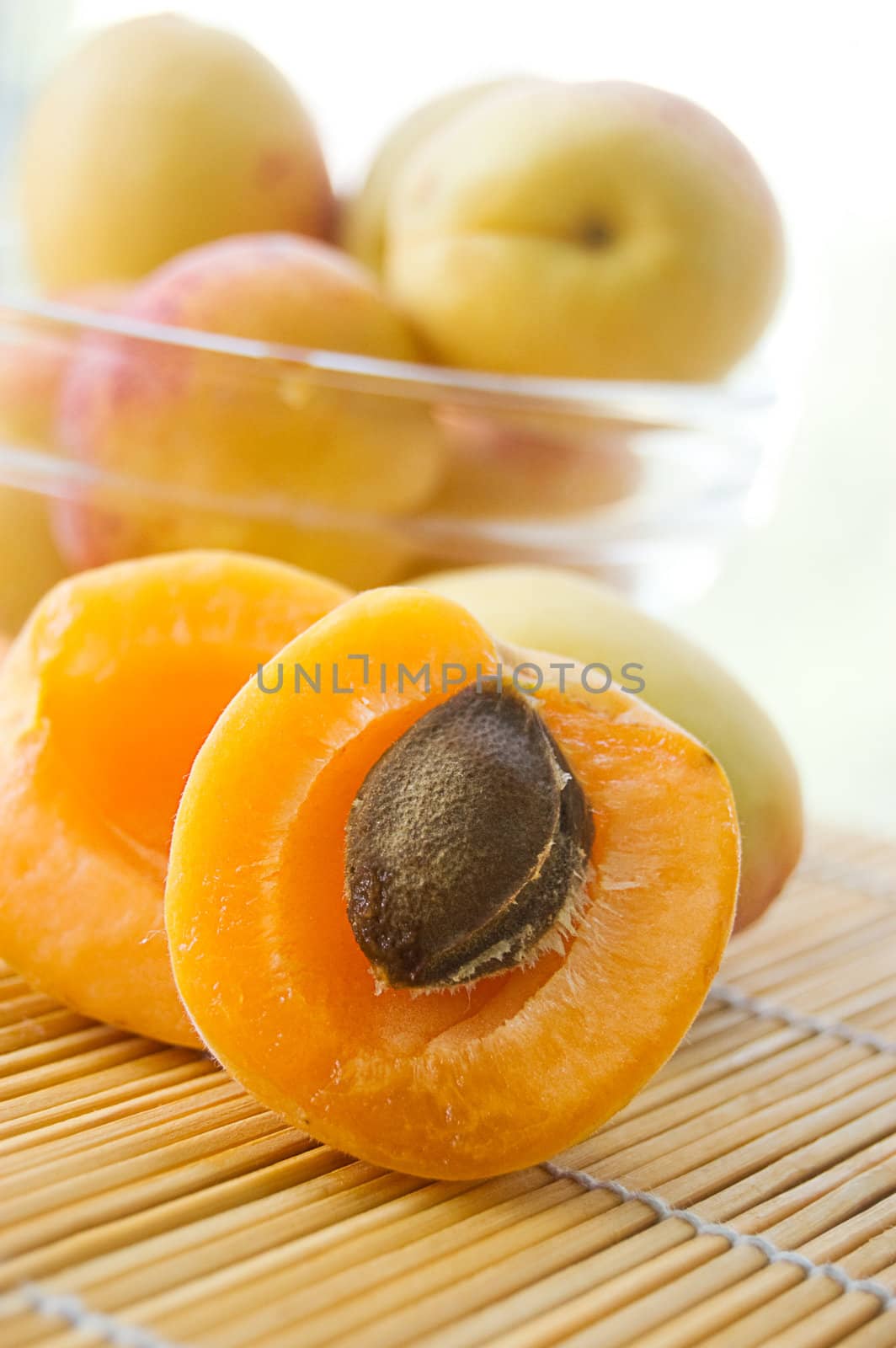 Fresh apricots in plate on lighten back