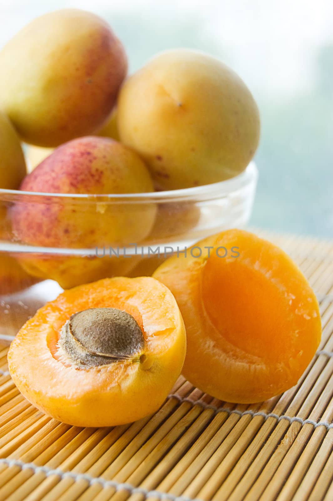 Ripe apricots in plate on table