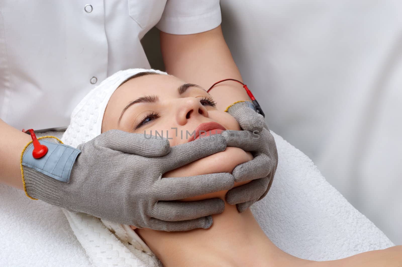 woman getting special facial massage in the beauty salon