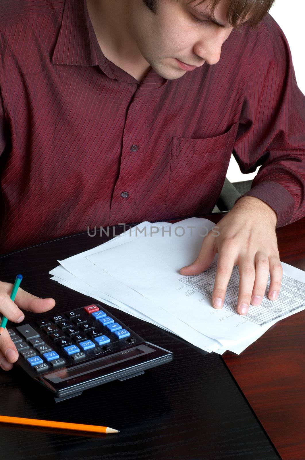 male accountatn accountant working with papers and calculator