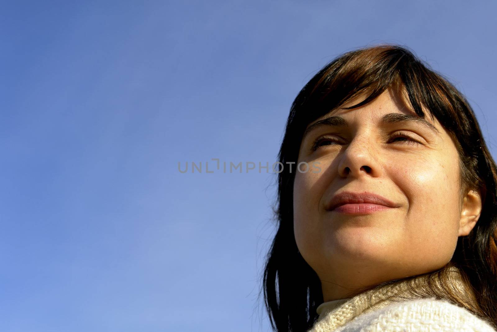 young woman close up portrait enjoying the sun