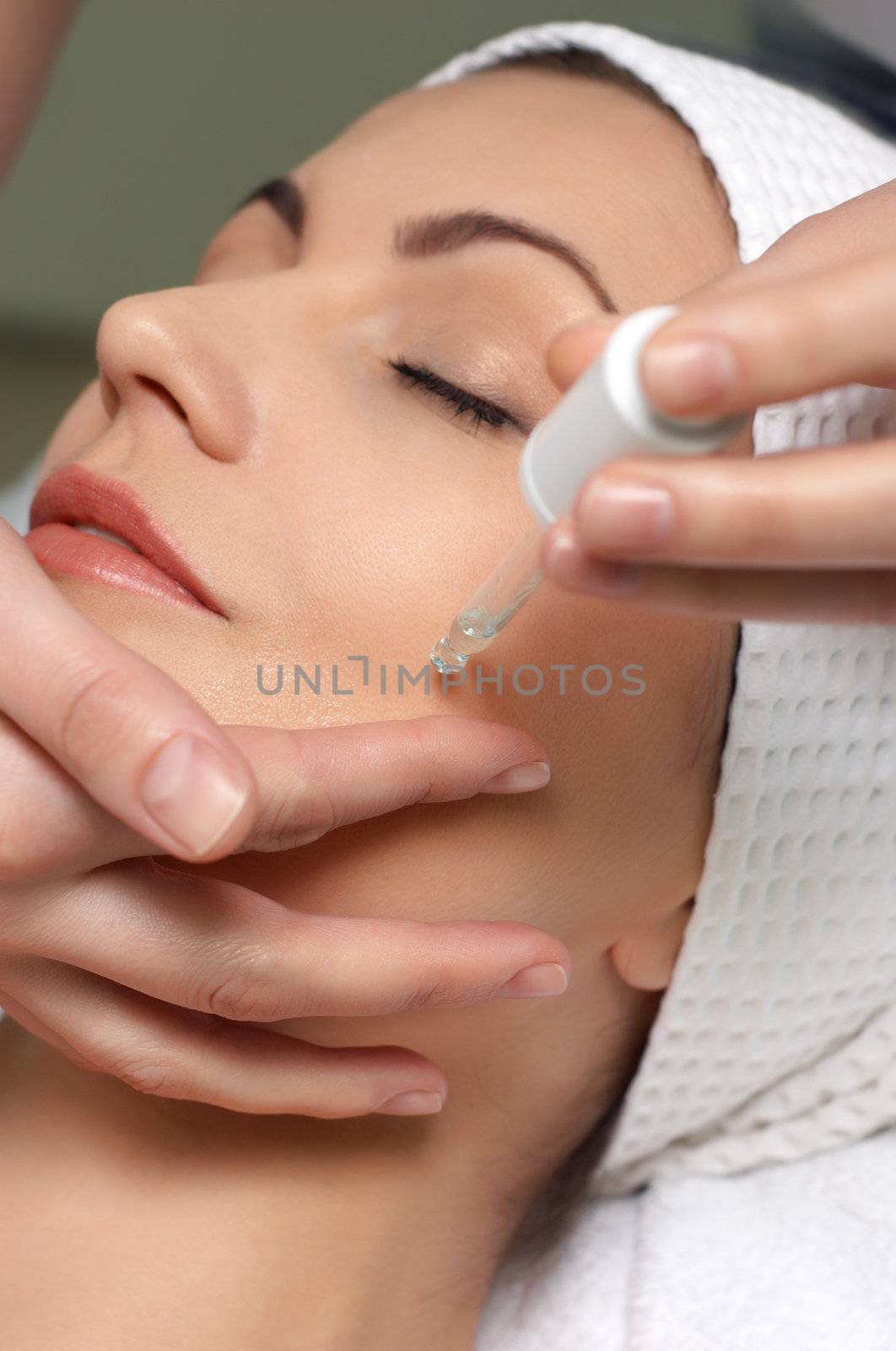 young pretty woman getting special skin treatment at beauty salon 