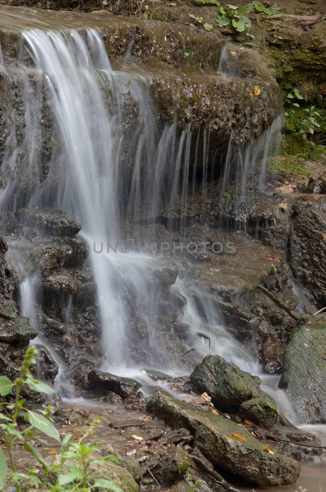 small waterfall in the forest. long exposure.