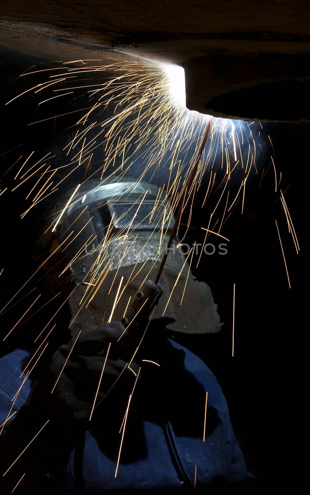 a welder working at shipyard at night