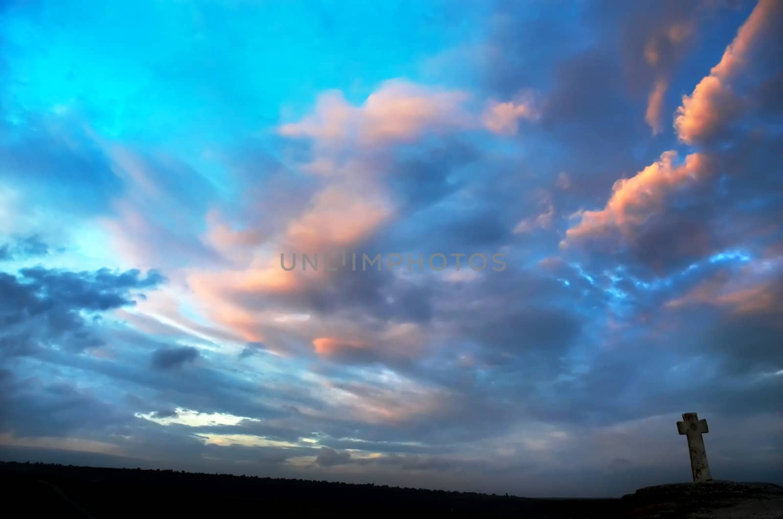 silhouette of stone cross on the sky background