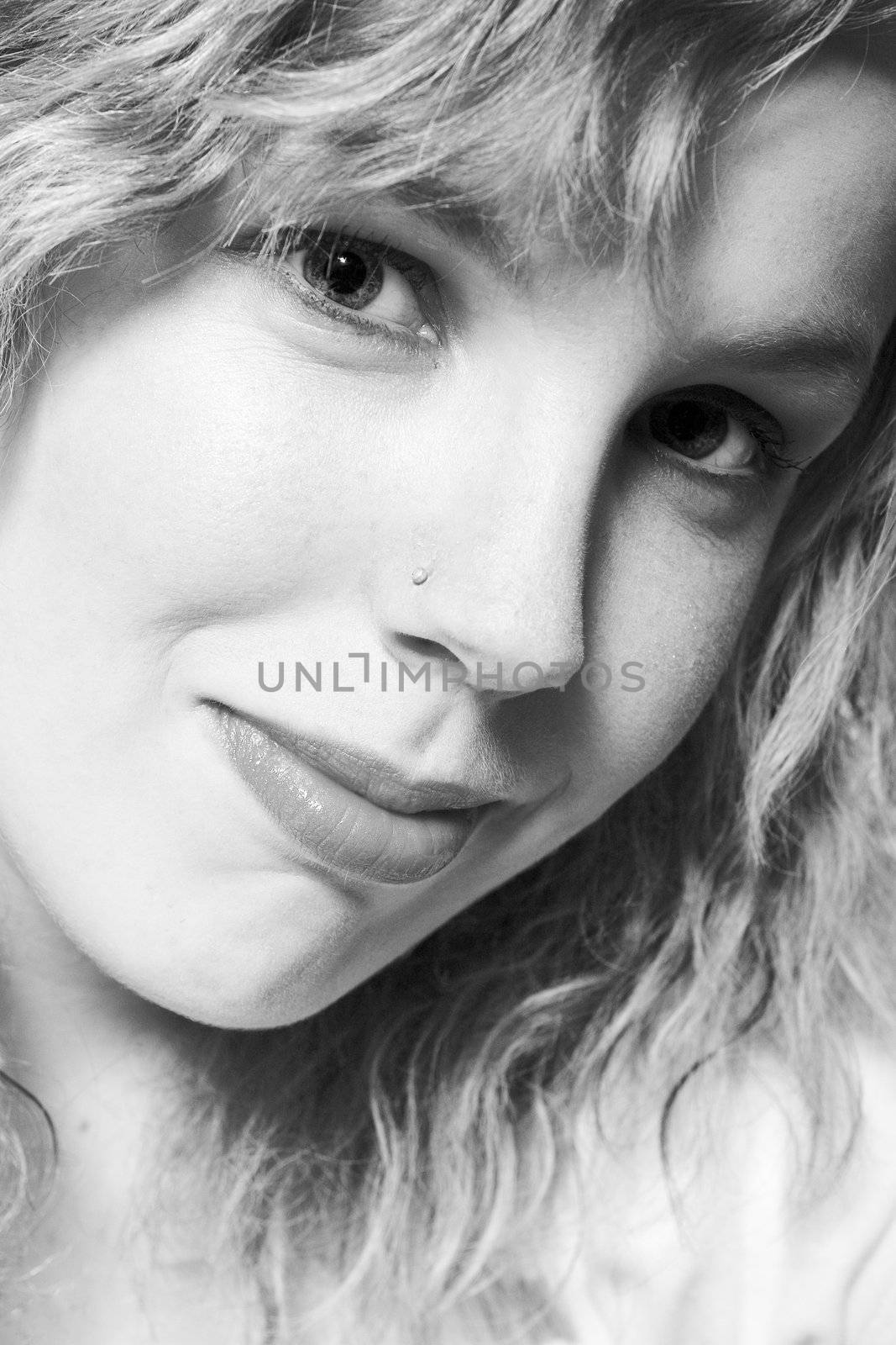 Studio portrait of a curly blond female