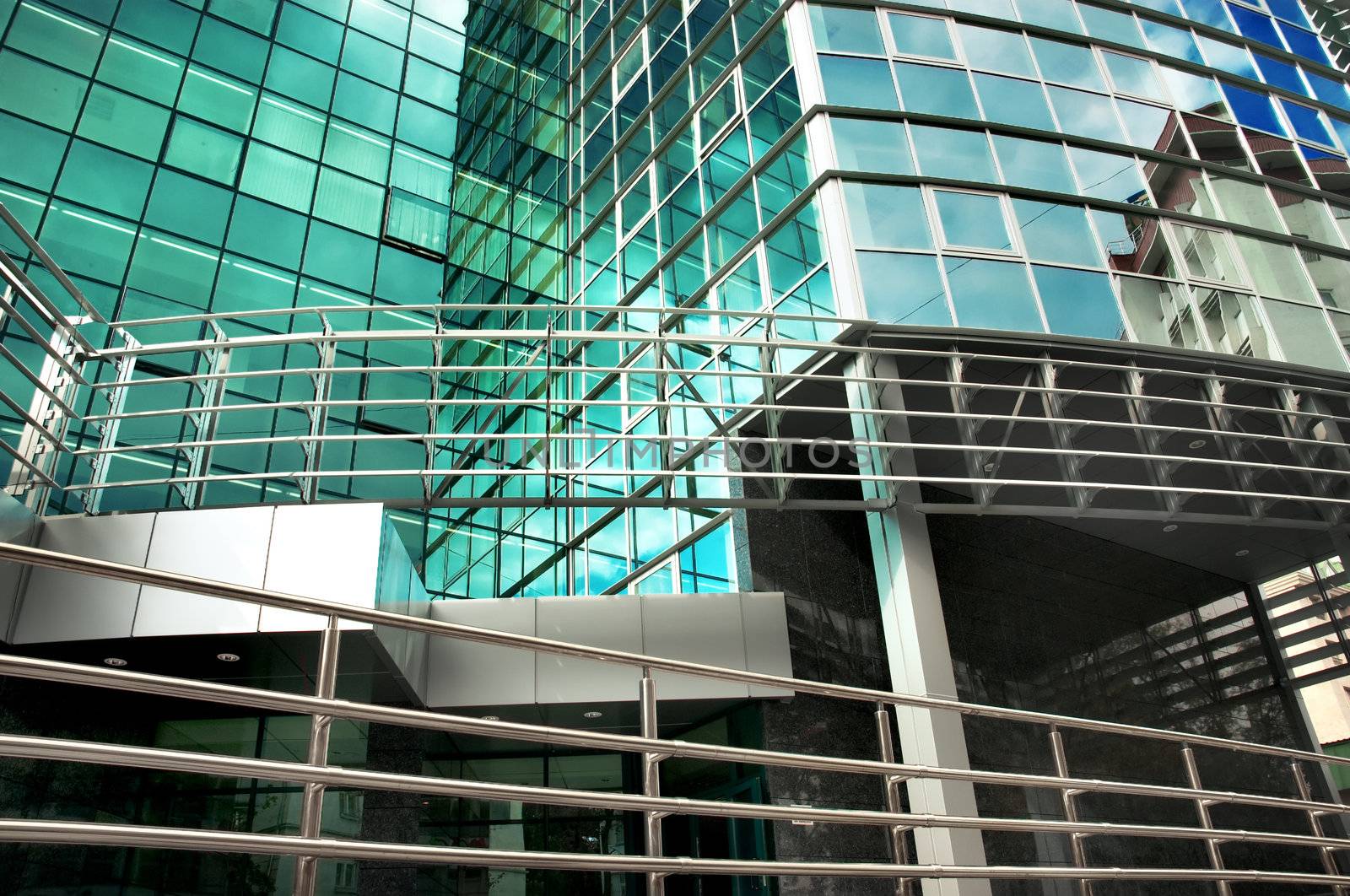 mirror-walled business center with reflection of cloudy sky