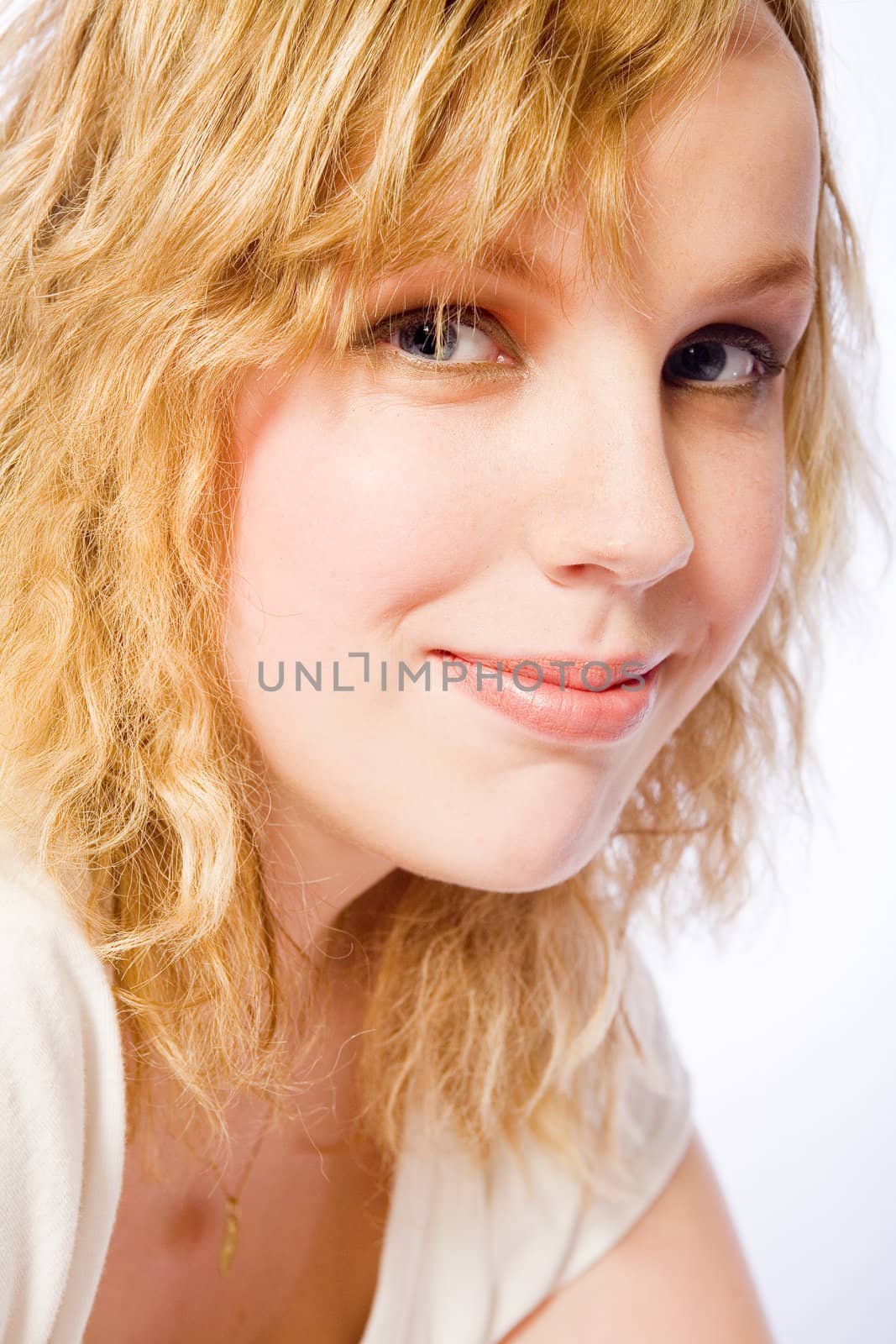 Studio portrait of a curly blond female