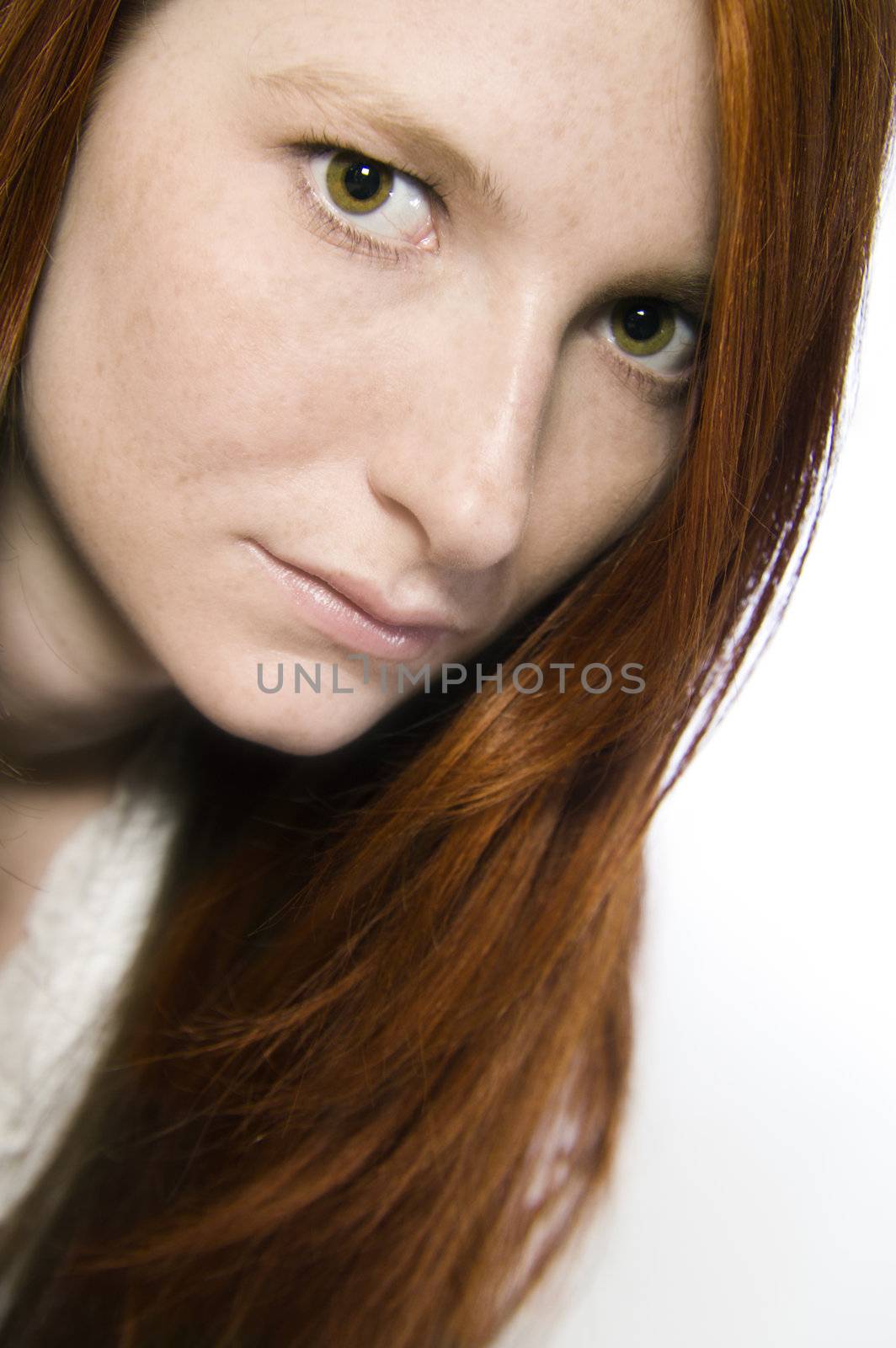 Studio portrait of a natural redhead looking interested