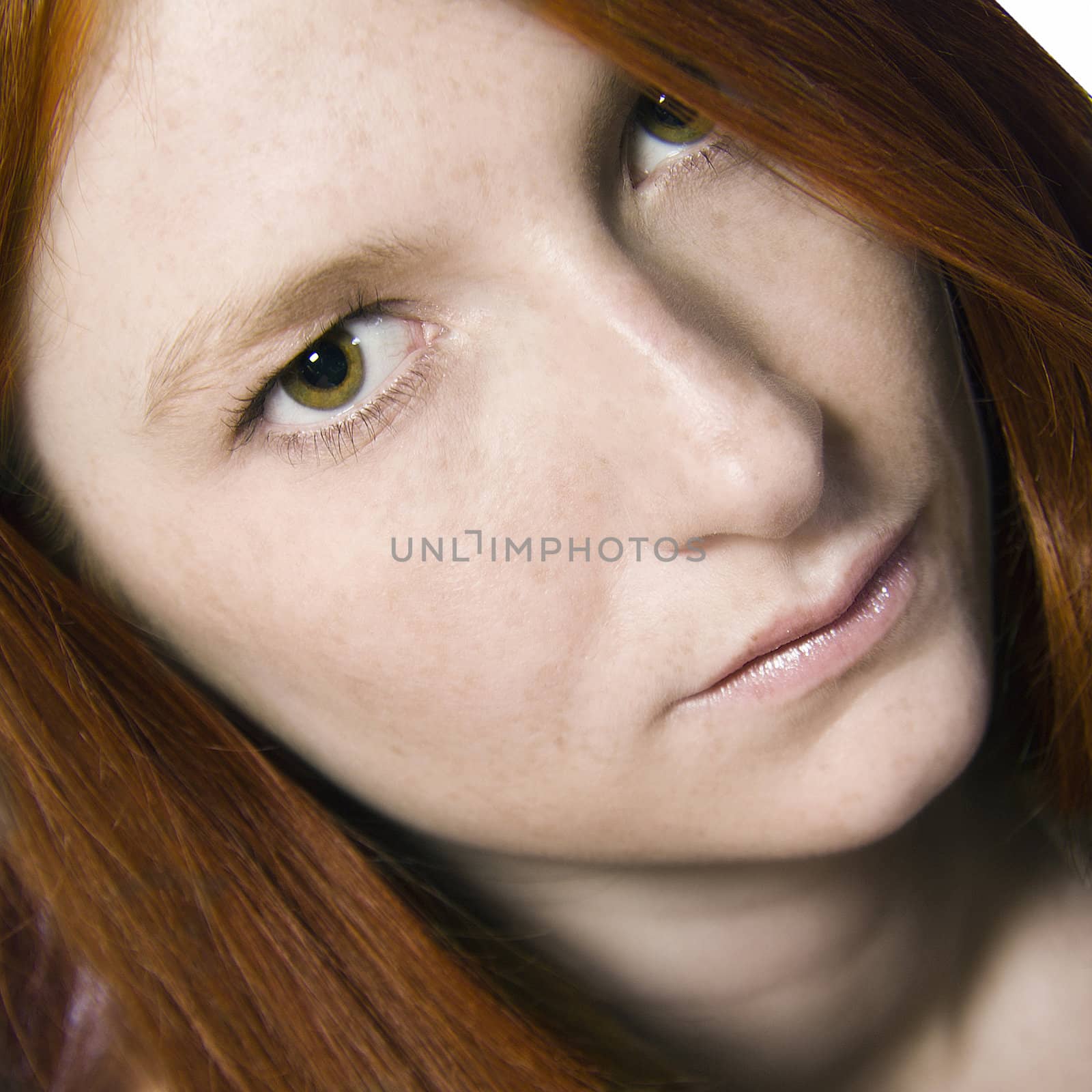Studio portrait of a natural redhead who is waiting for an answer