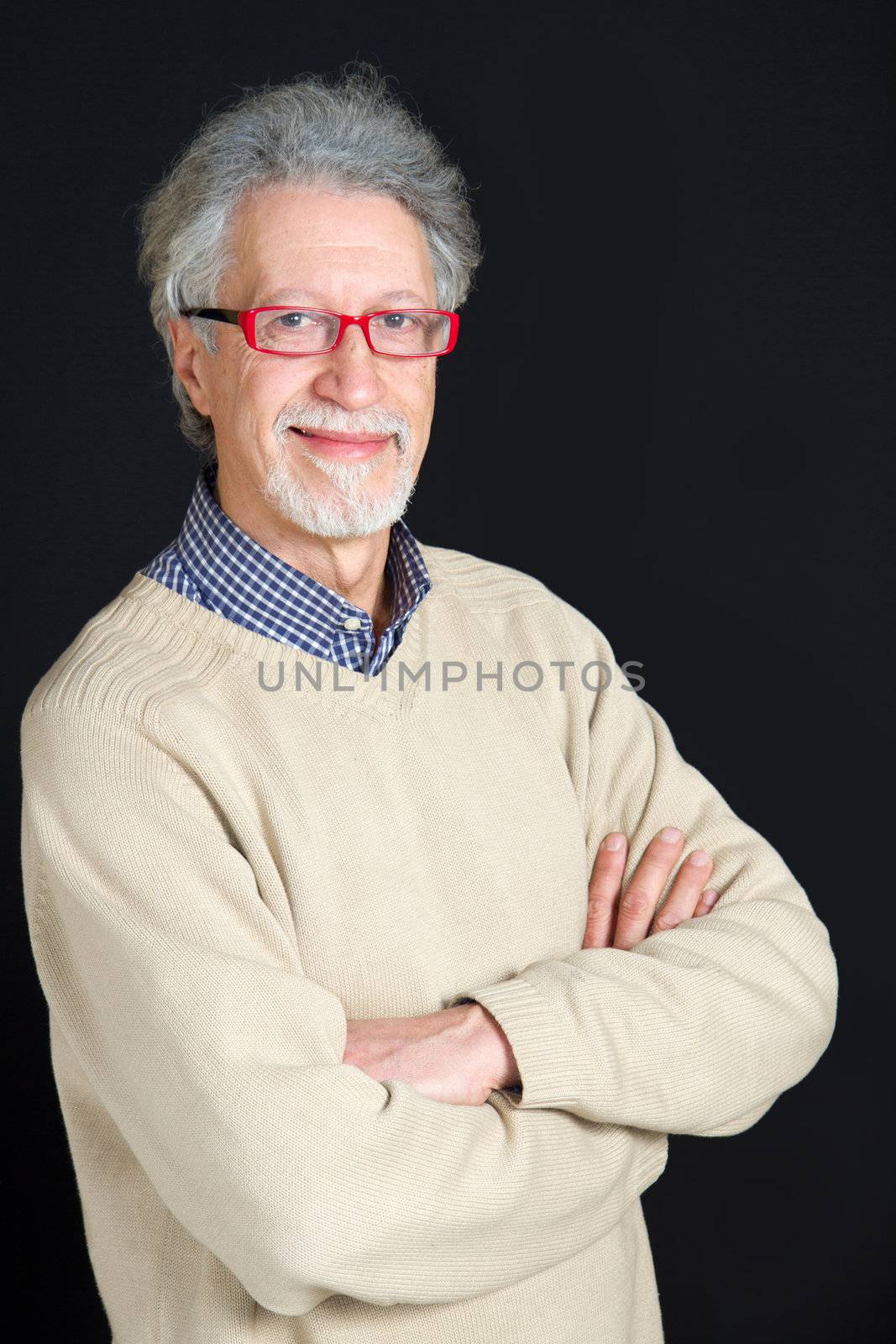 Portrait of a happy mature man isolated on black background 
