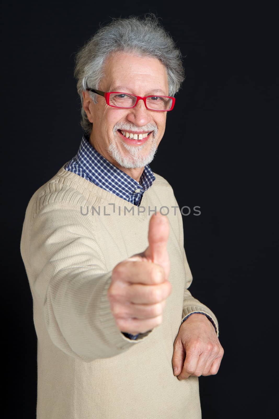Portrait of a happy mature man isolated on black background 