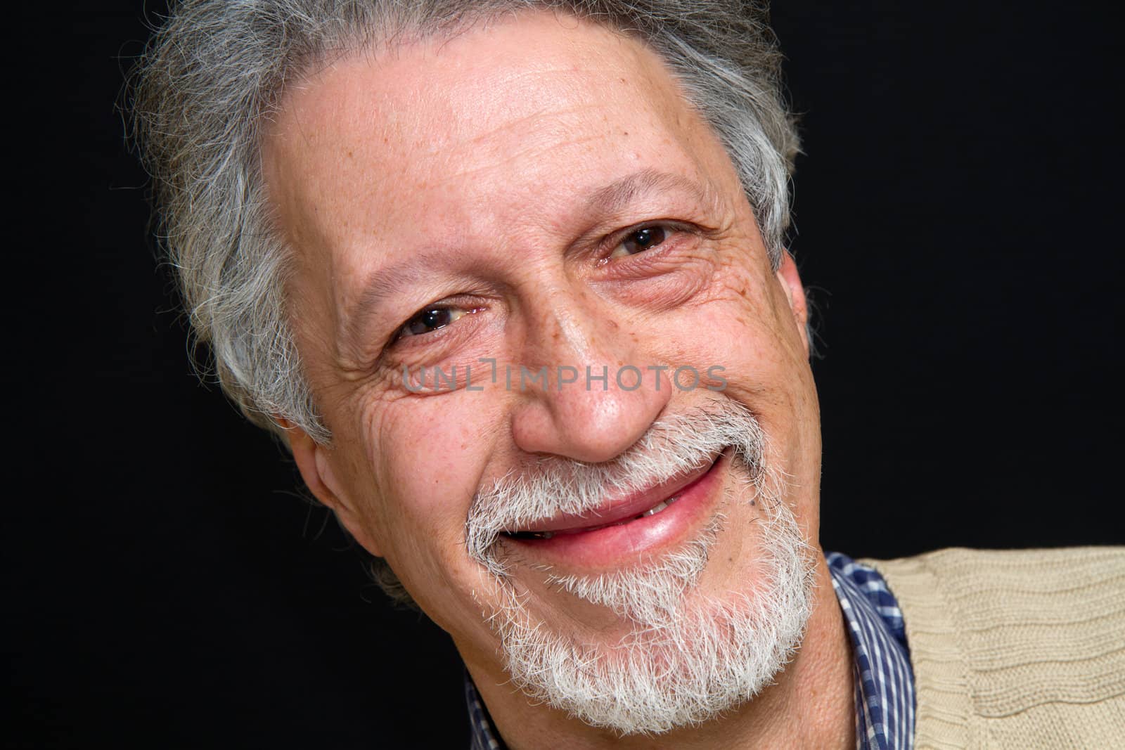 Portrait of a happy mature man isolated on black background