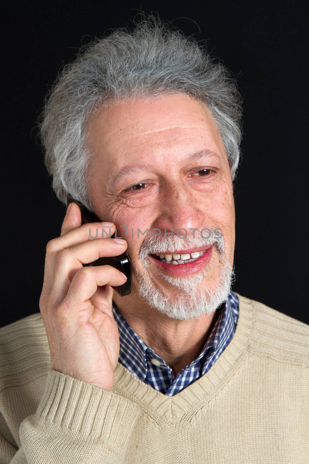 mature man talking on his mobile phone  by lsantilli
