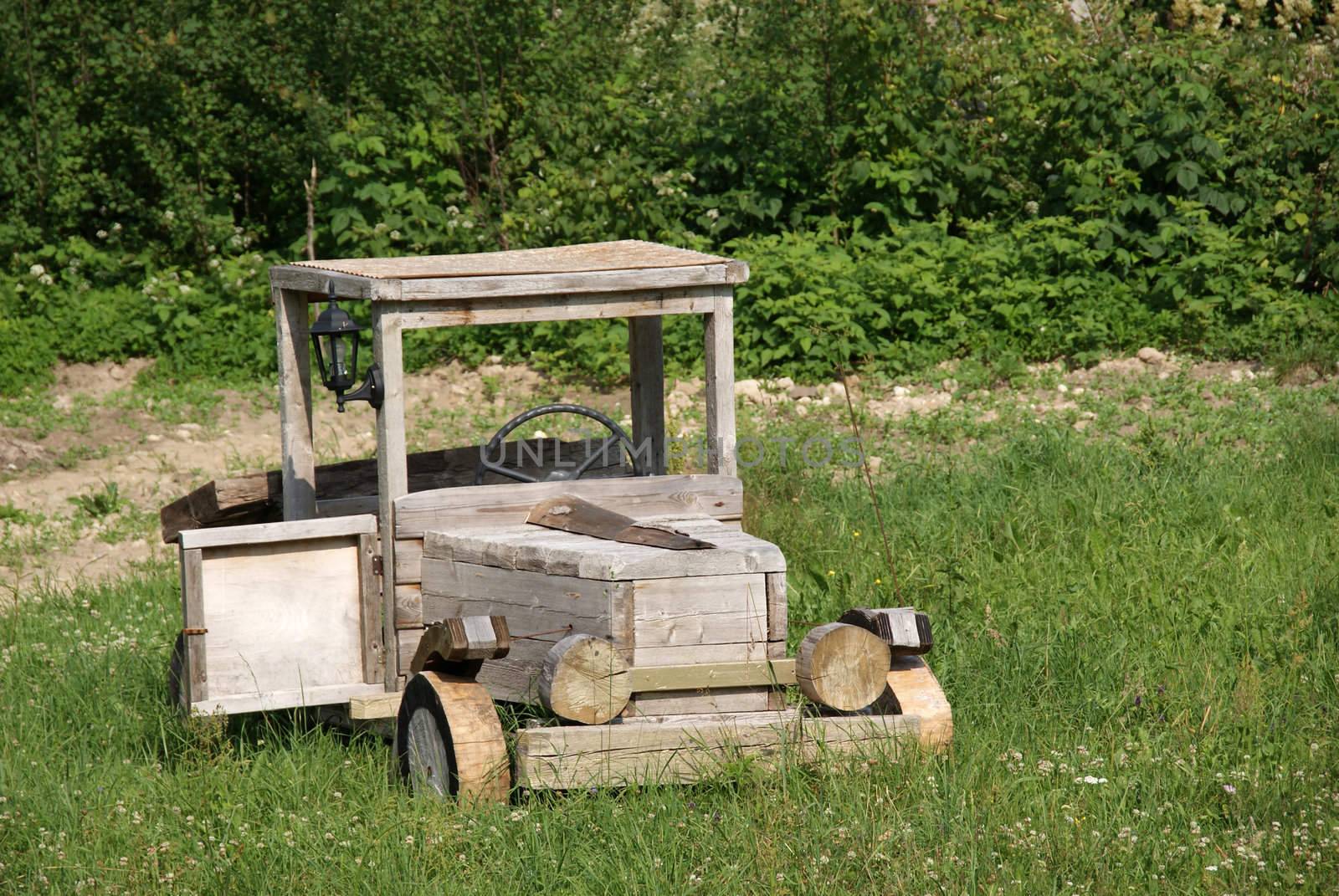 Wooden truck stands in a field in grass