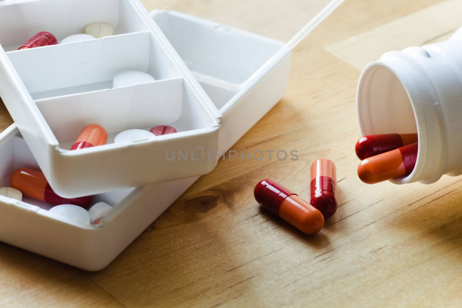 Pills, capsules and tablets sorted in pillbox by Colette