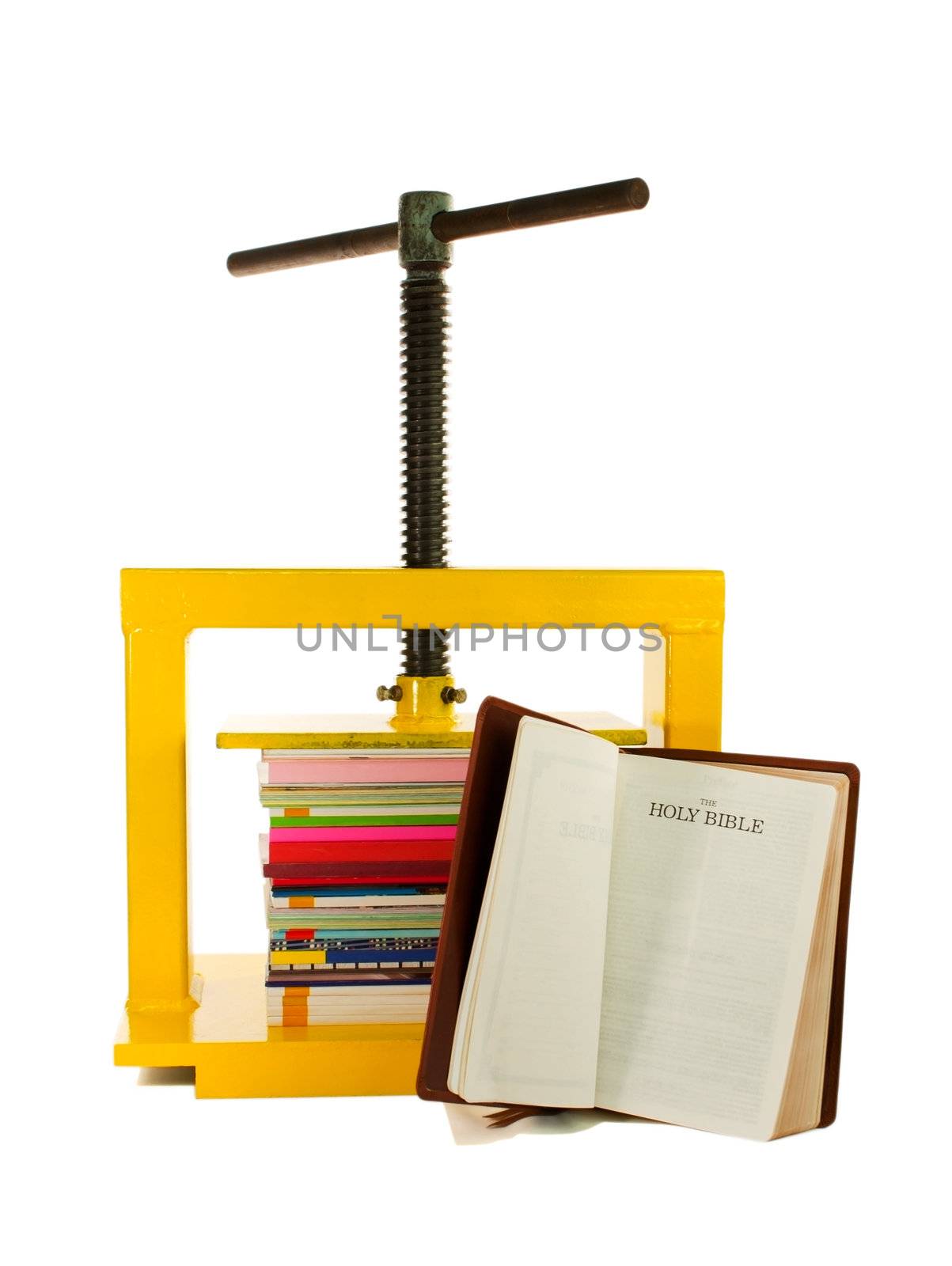 The Bible concept - Pile of colourful books under the press and the Bible isolated on white