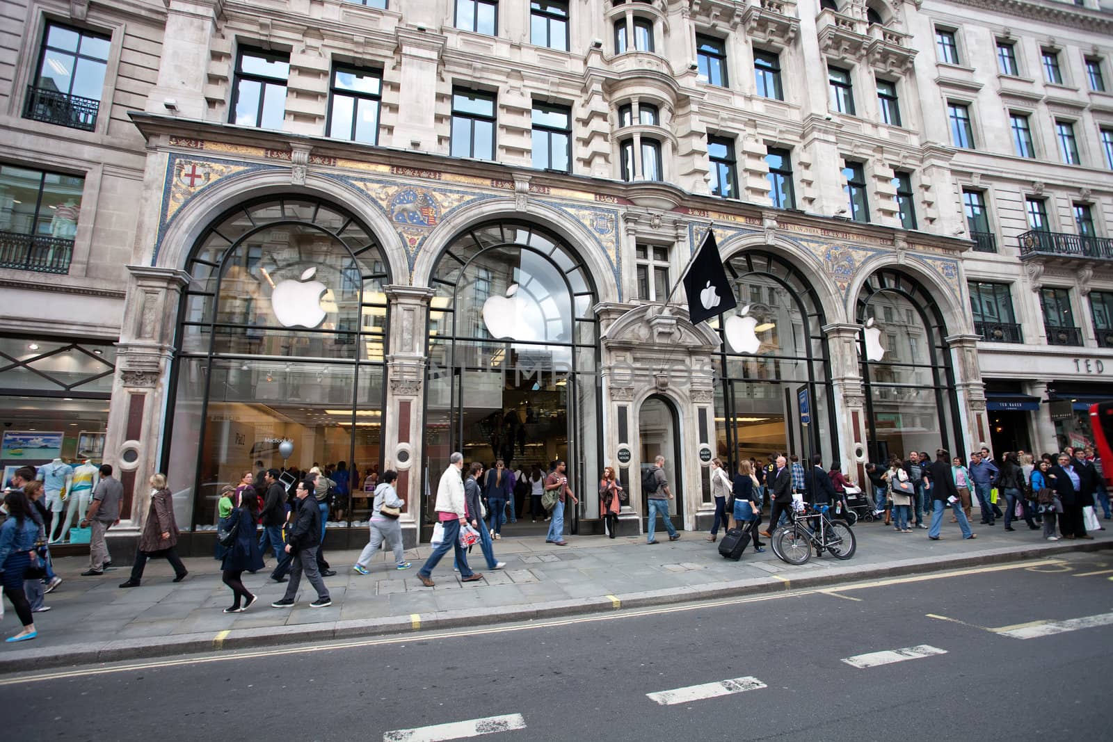 London, United Kingdom - June 13, 2011: People near Entrance to Apple store in Regent Street central London on June 13, 2011. The Apple Store is a dealing computers and consumer electronics produced by Apple and third parties as well.