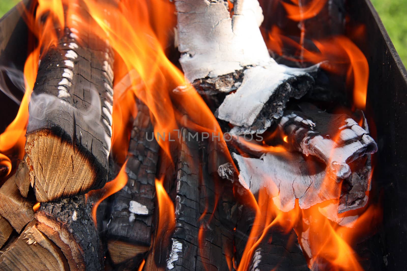 Dry wood burns slowly in the grill