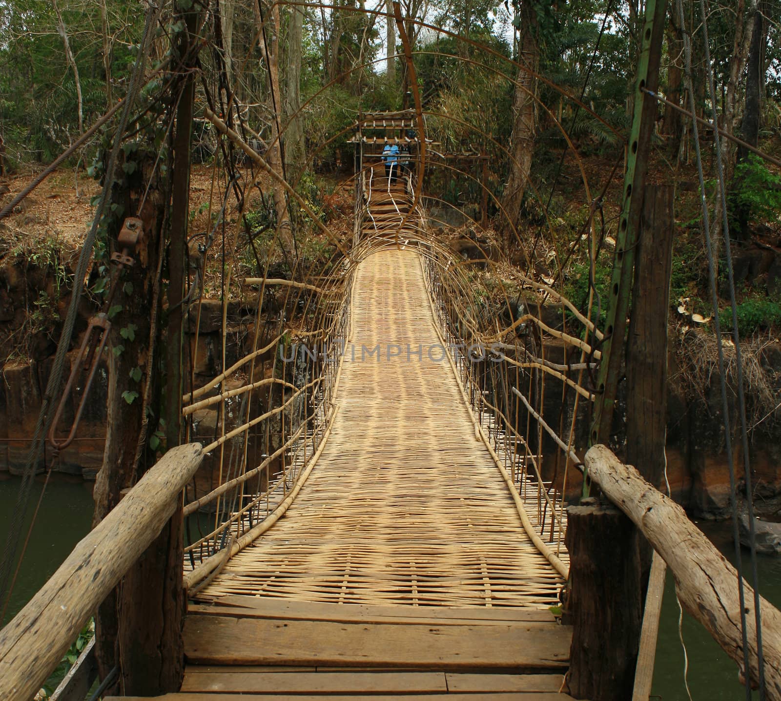 Hanging bamboo bridge over river