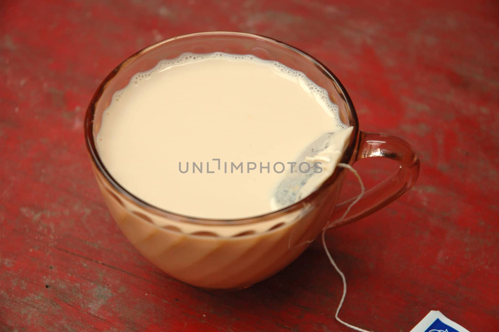 hot tea with milk on porcelain glass
