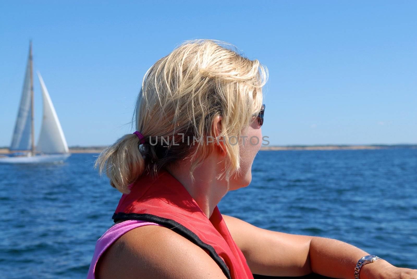 Scandinavian Lifestyle - a woman looking over the sea by Bildehagen