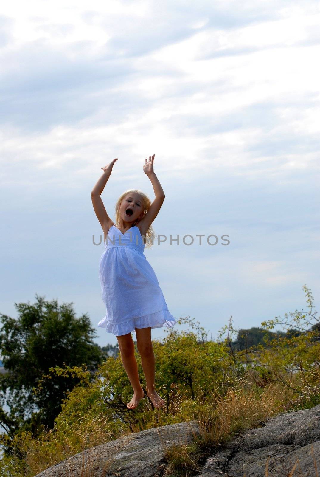 girl playing by the seaside. Please note: No negative use allowed.