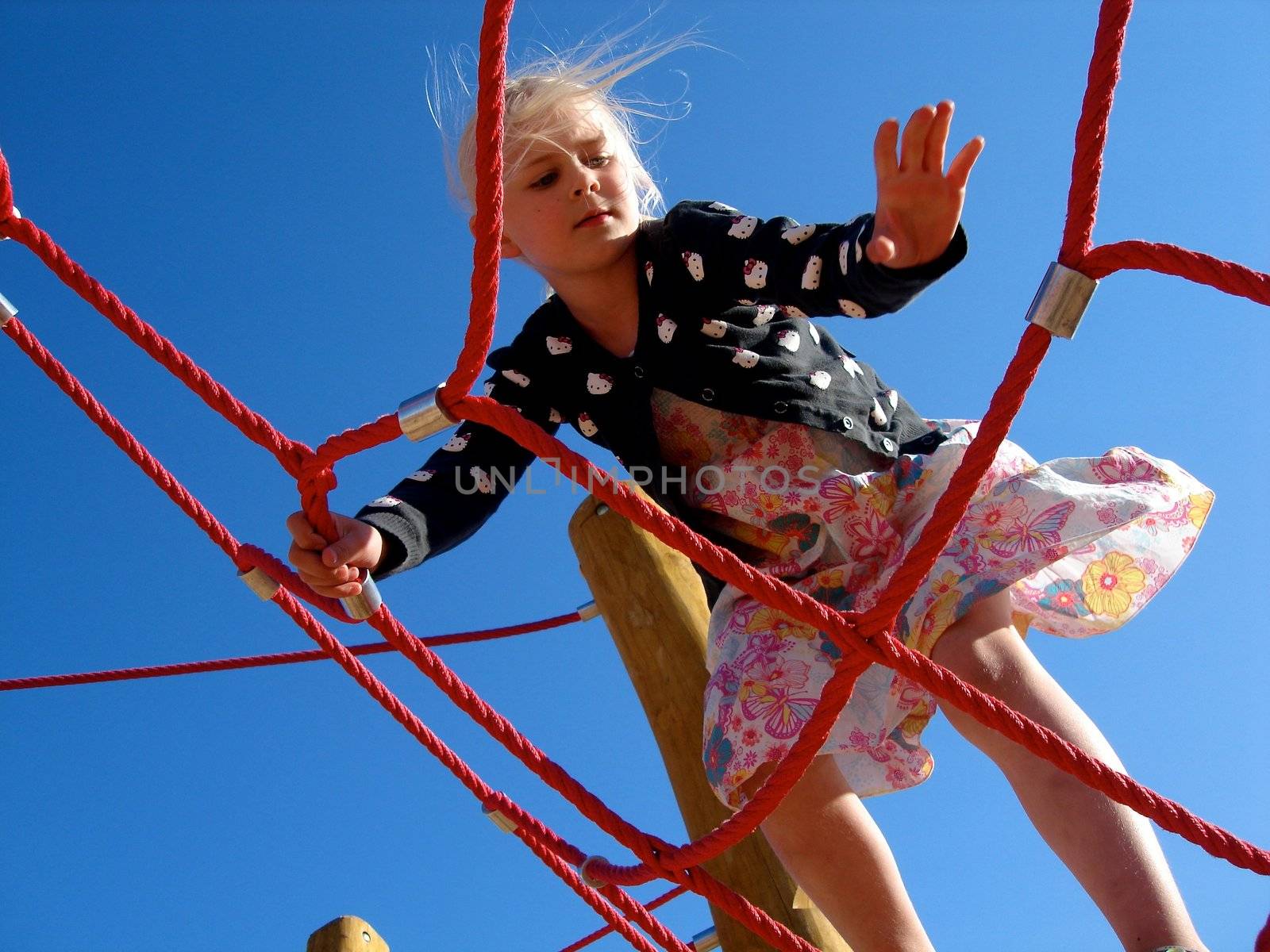 a girl is climbing up. Please note: No negative use allowed.