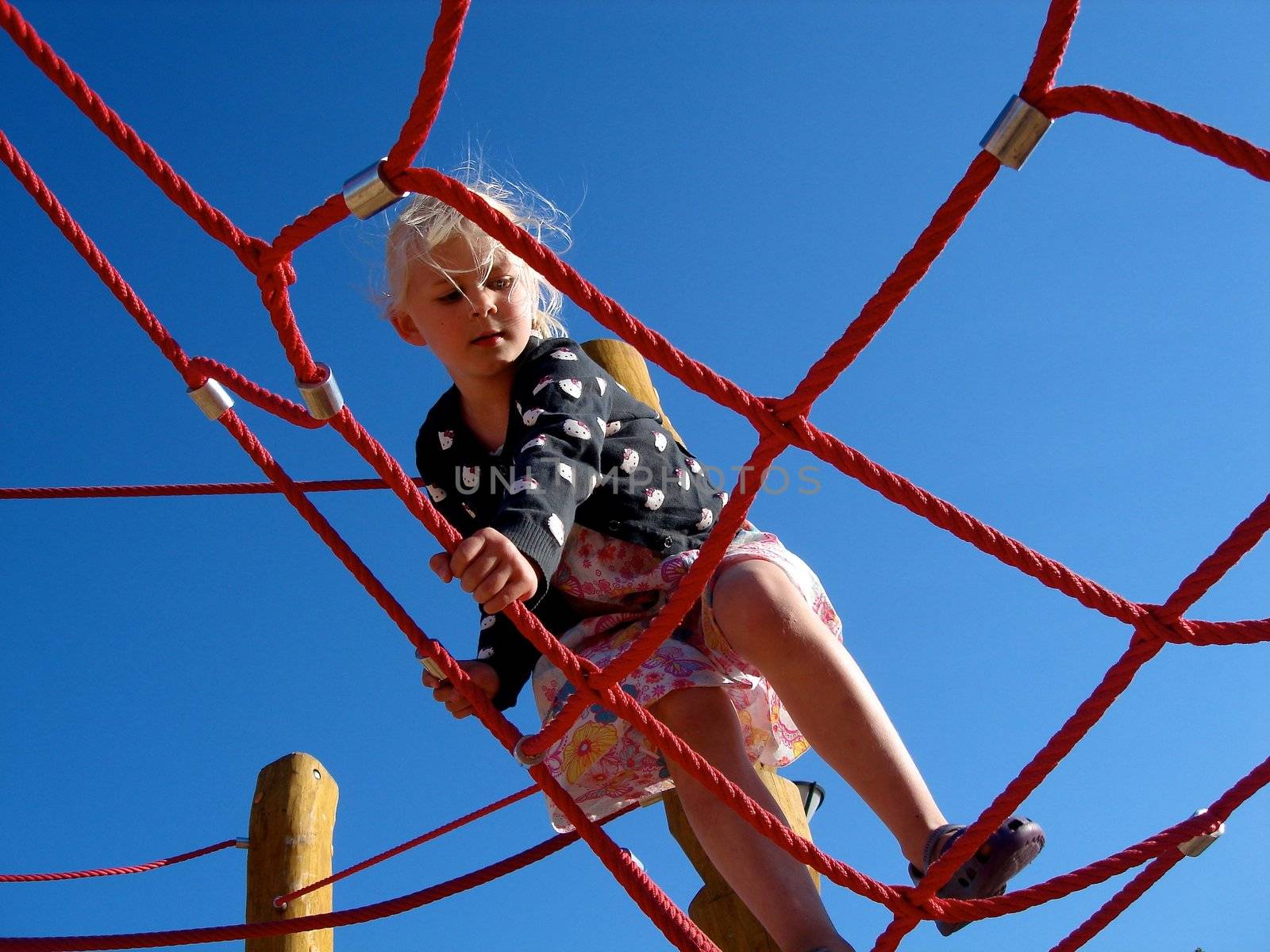 a girl is climbing up. Please note: No negative use allowed.