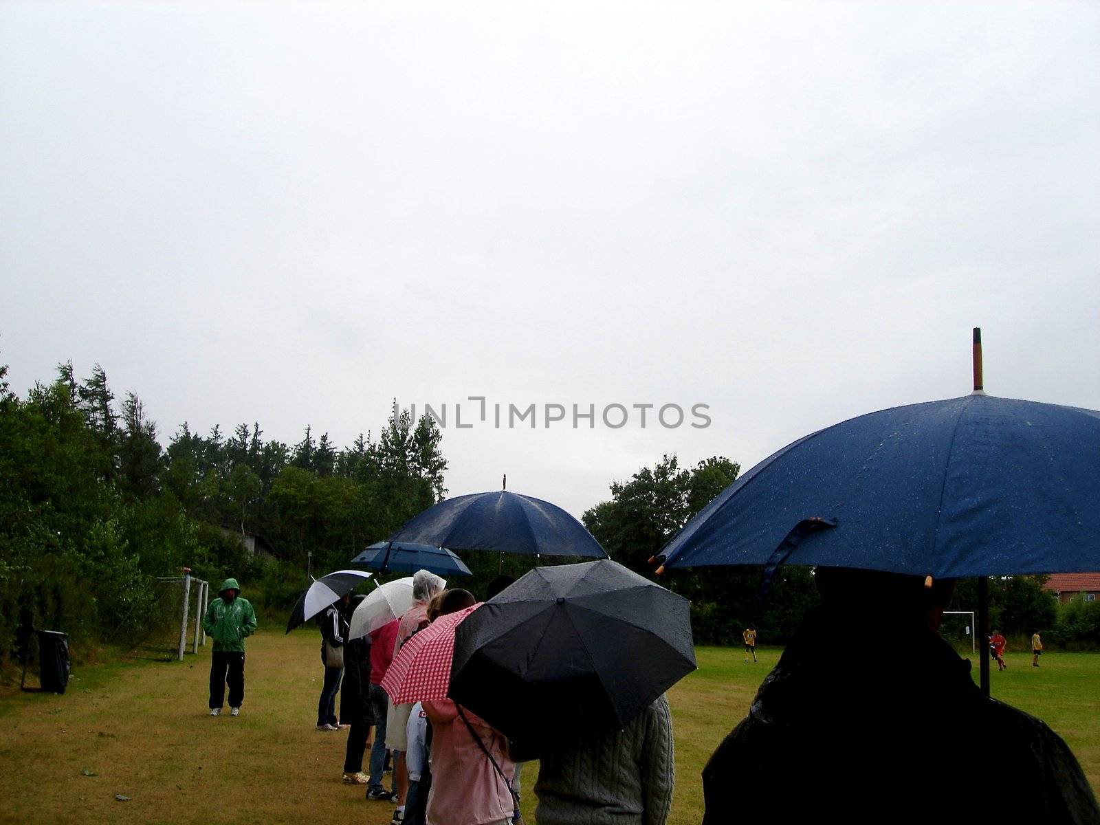 watching a football game in the rain. Please note: No negative use allowed.