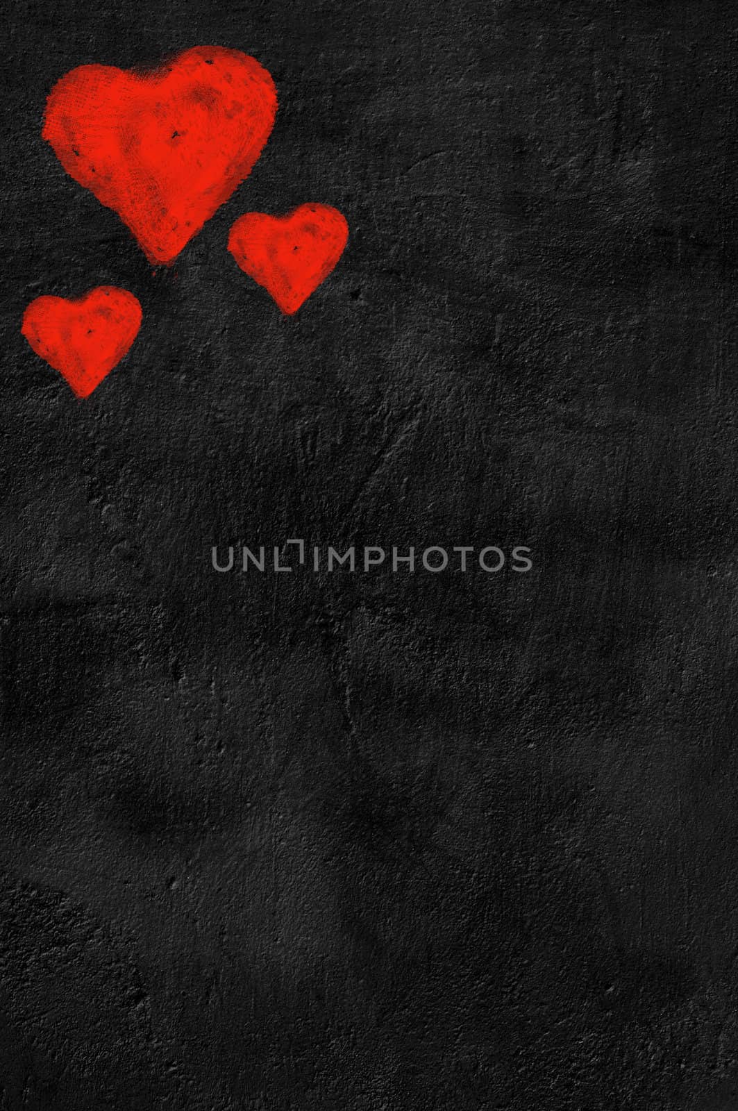 Three red hearts on black background