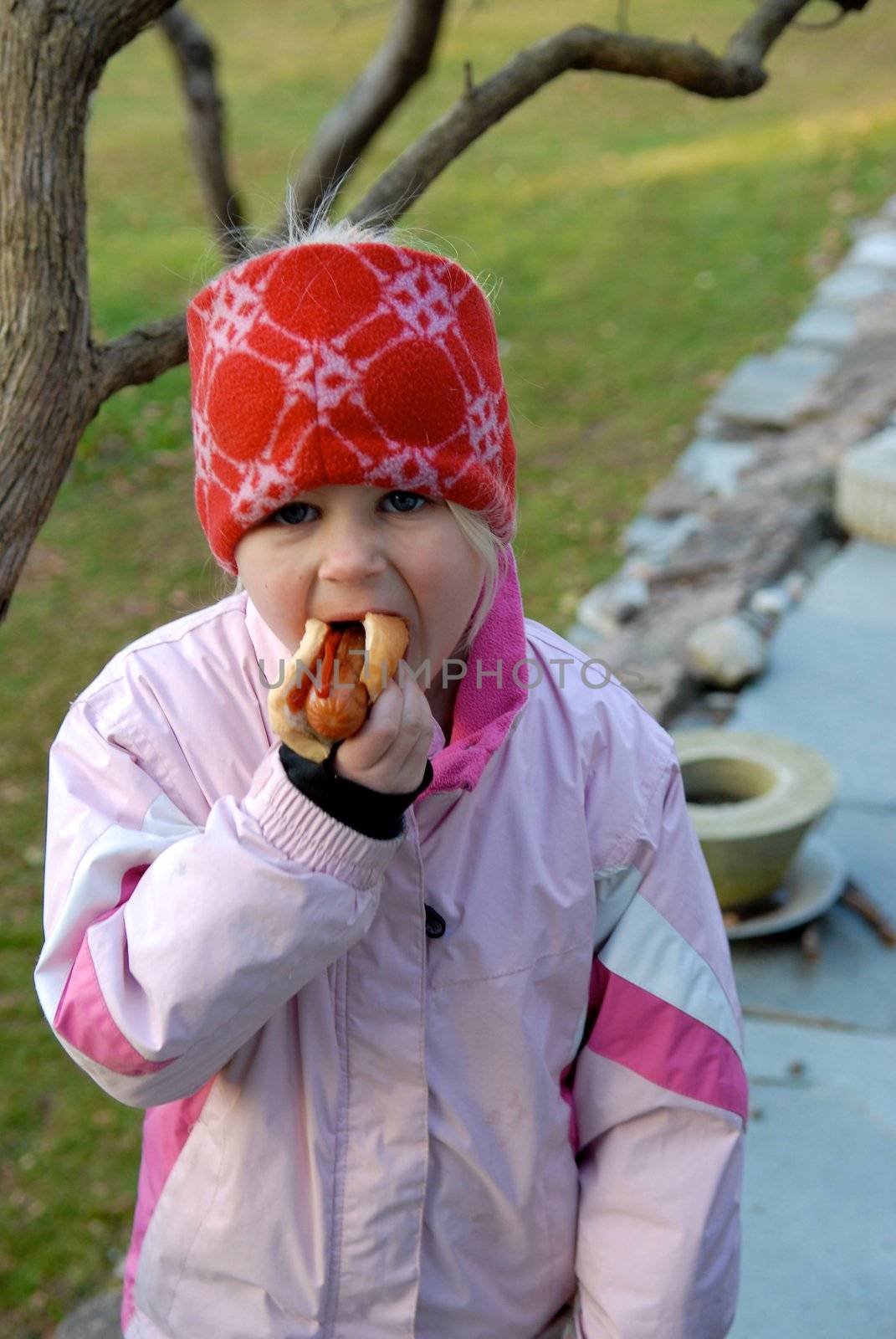 girl eating the hot dog. Please note: No negative use allowed.